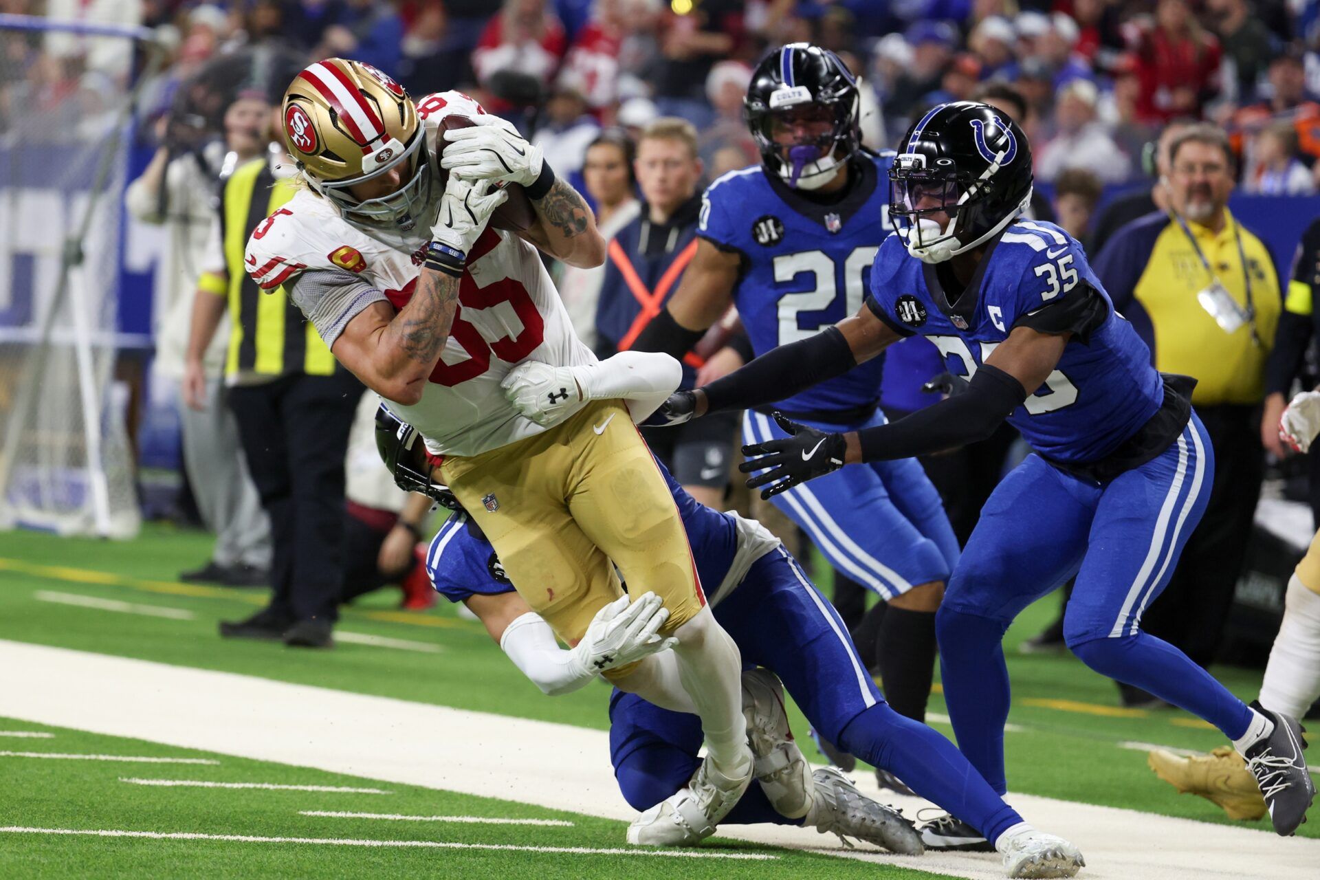 Indianapolis Colts safety Cam Bynum (0) tackles San Francisco 49ers tight end George Kittle (85) in the third quarter of the game at Lucas Oil Stadium.