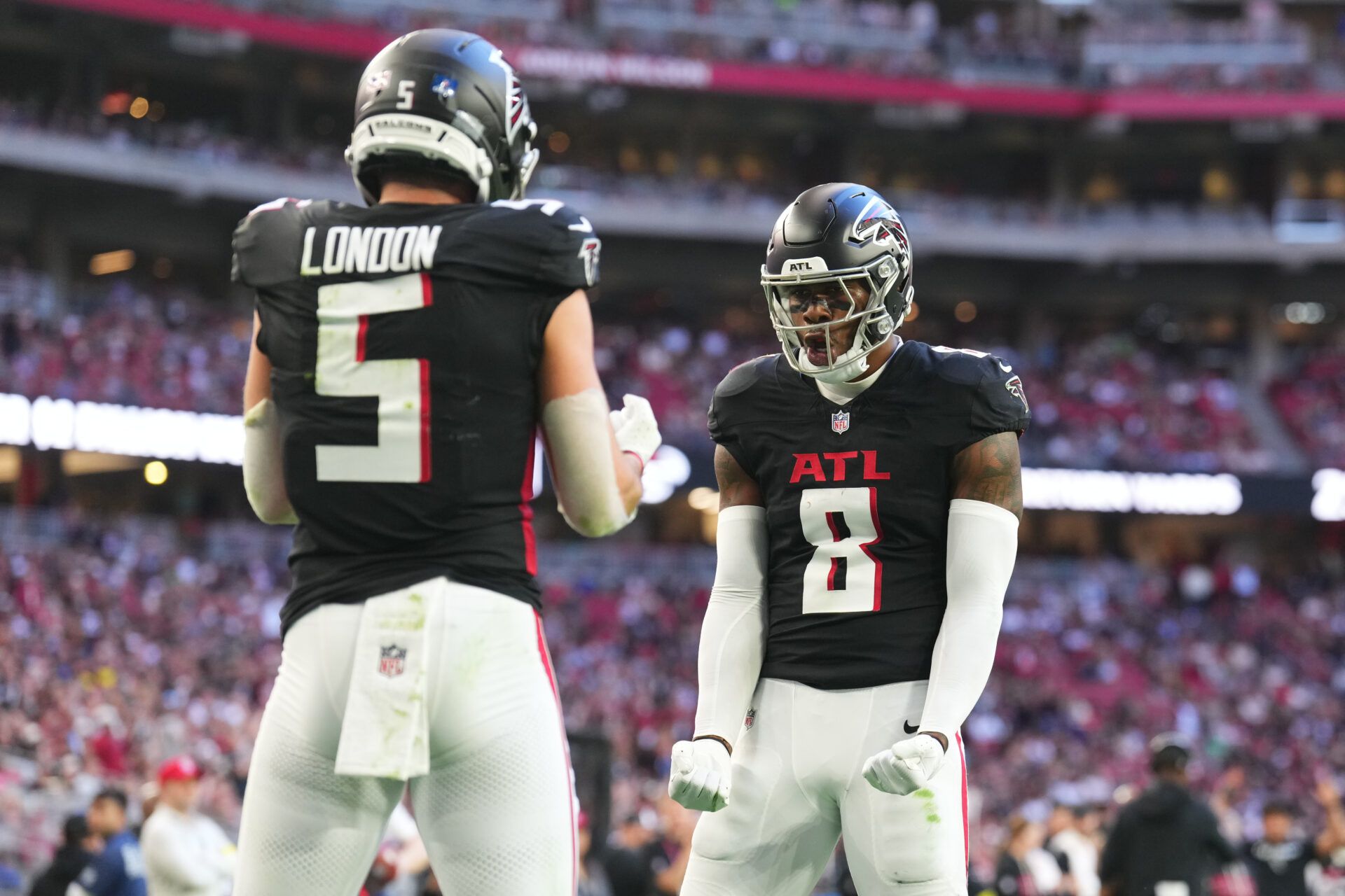 Atlanta Falcons tight end Kyle Pitts Sr. (8) reacts with wide receiver Drake London (5) after catching a touchdown against the Arizona Cardinals during the first half at State Farm Stadium.