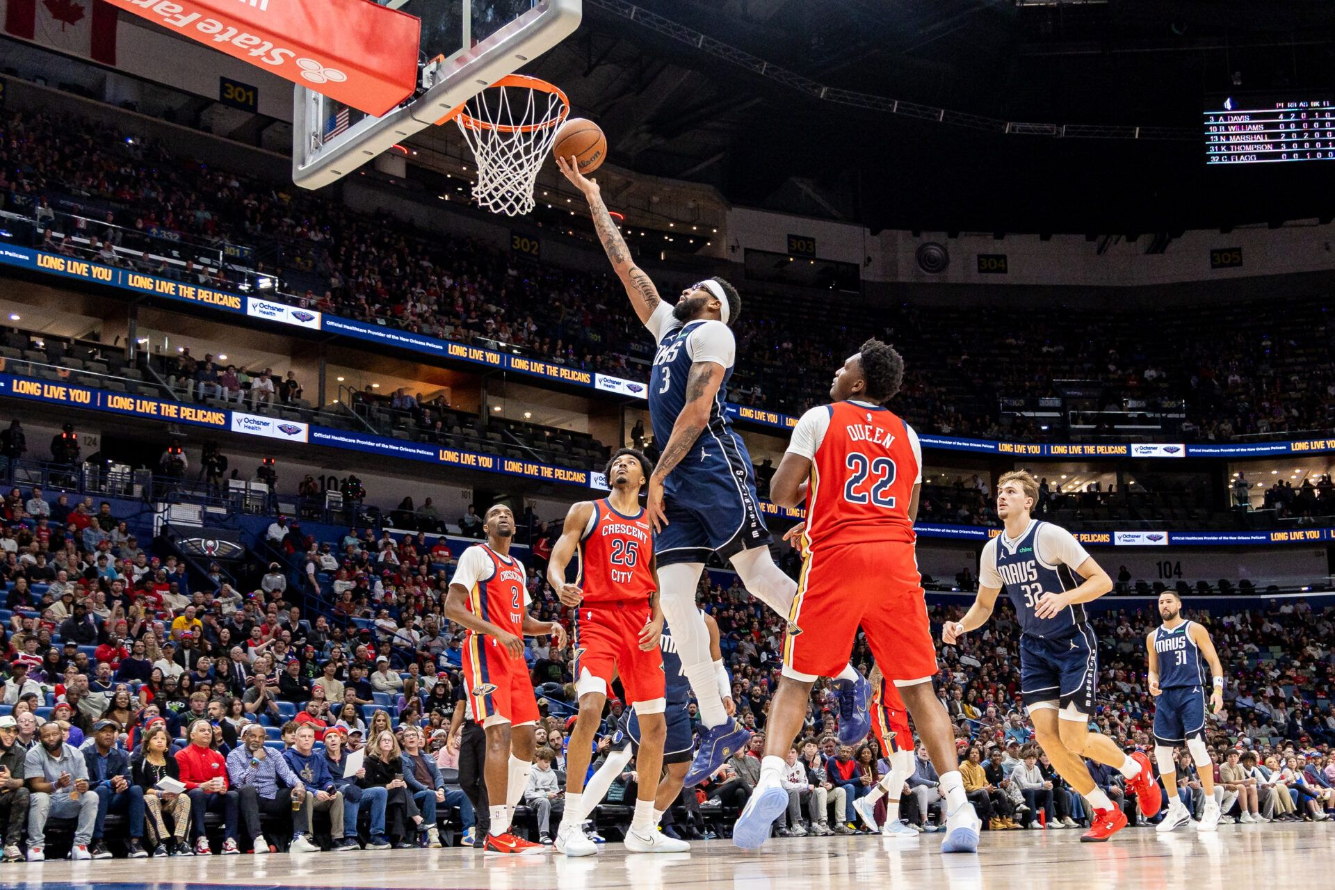 Dallas Mavericks forward/center Anthony Davis (3) drives to the basket against New Orleans Pelicans forward Trey Murphy III (25) and center Derik Queen (22) during the first half at Smoothie King Center.