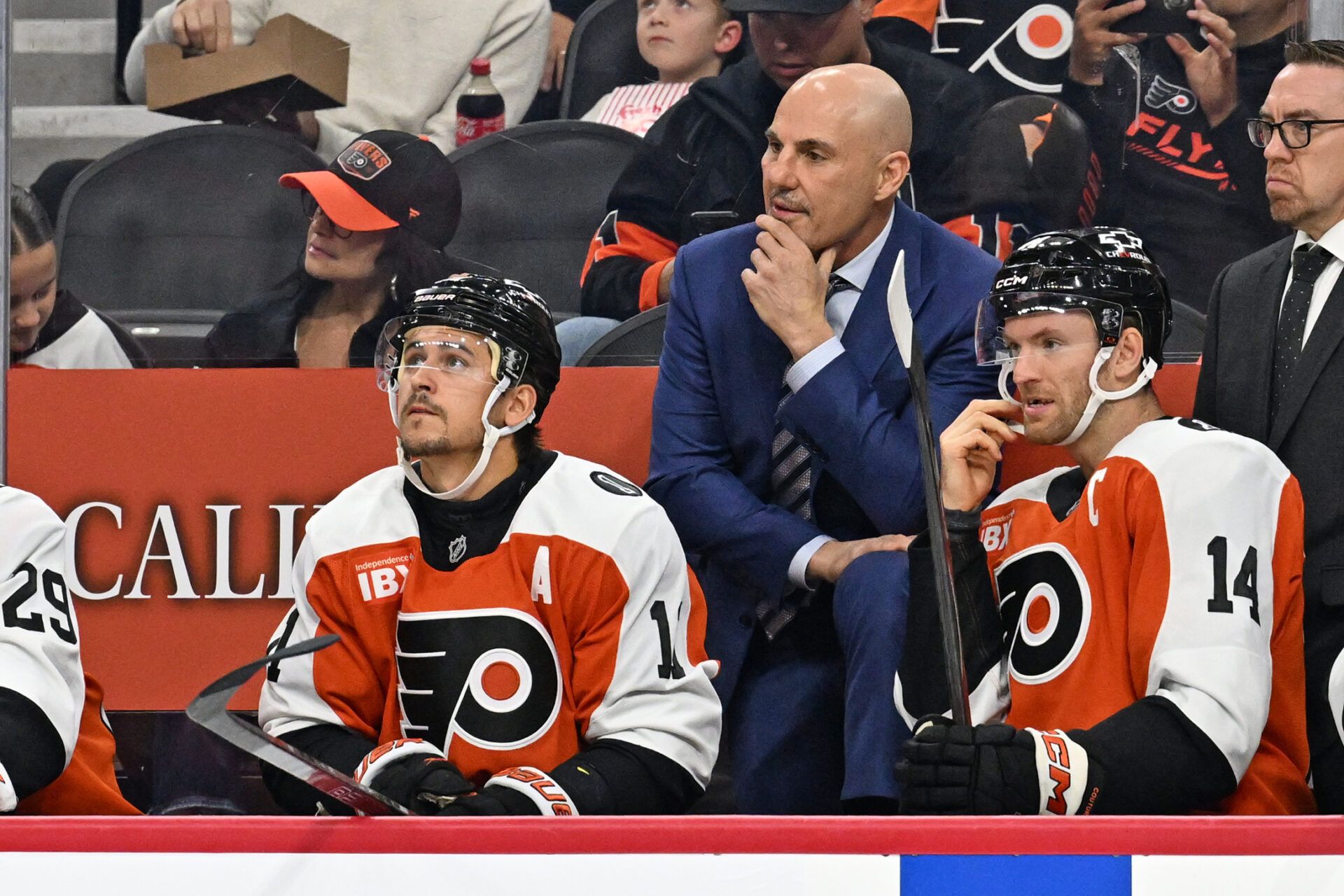 Philadelphia Flyers head coach Rick Tocchet with right wing Travis Konecny (11) and center Sean Couturier (14) against the Florida Panthers during the first period at Wells Fargo Center.