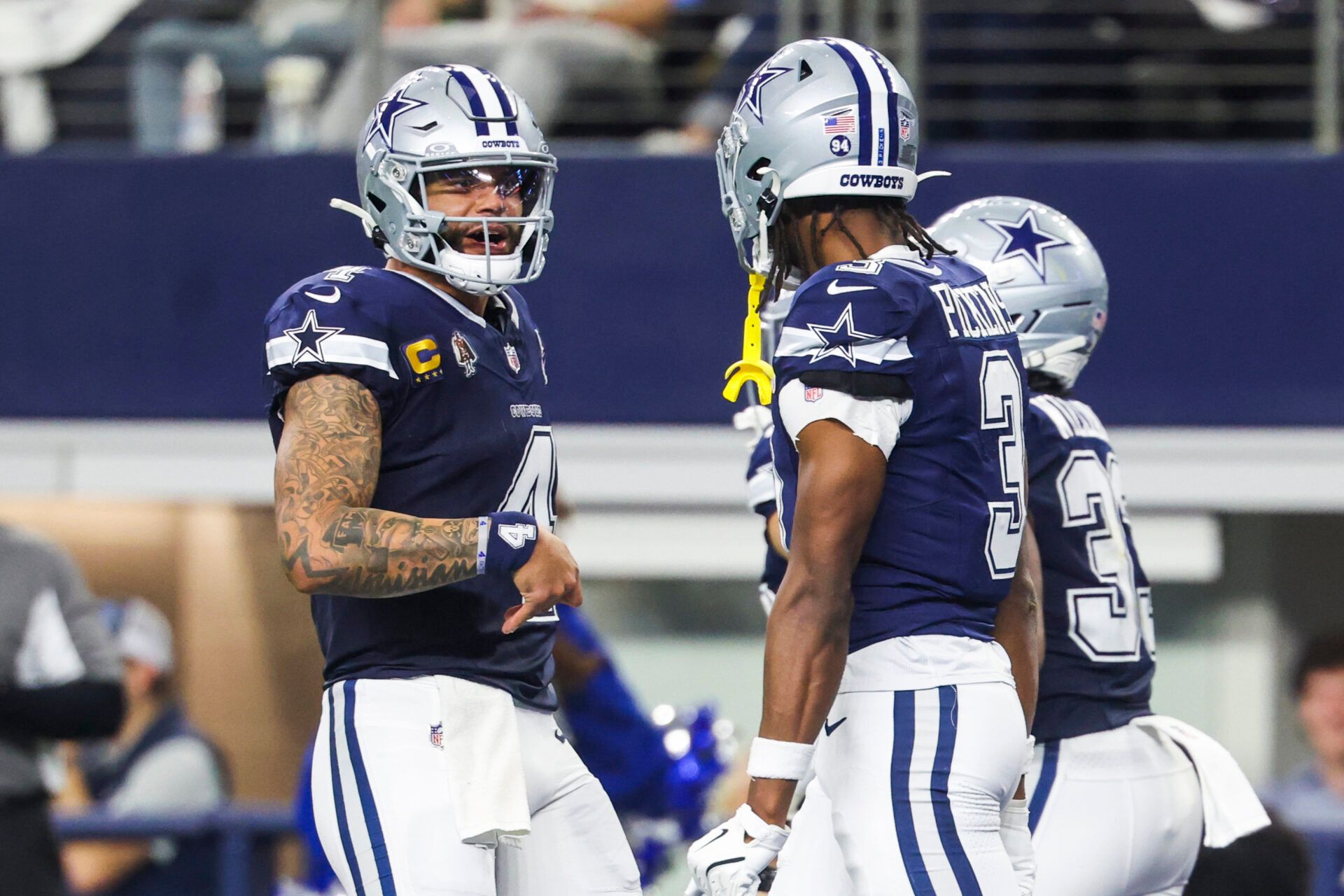 Dallas Cowboys quarterback Dak Prescott (4) celebrates with wide receiver George Pickens (3) after a touchdown pass caught by Pickens during the second quarter at AT&T Stadium.