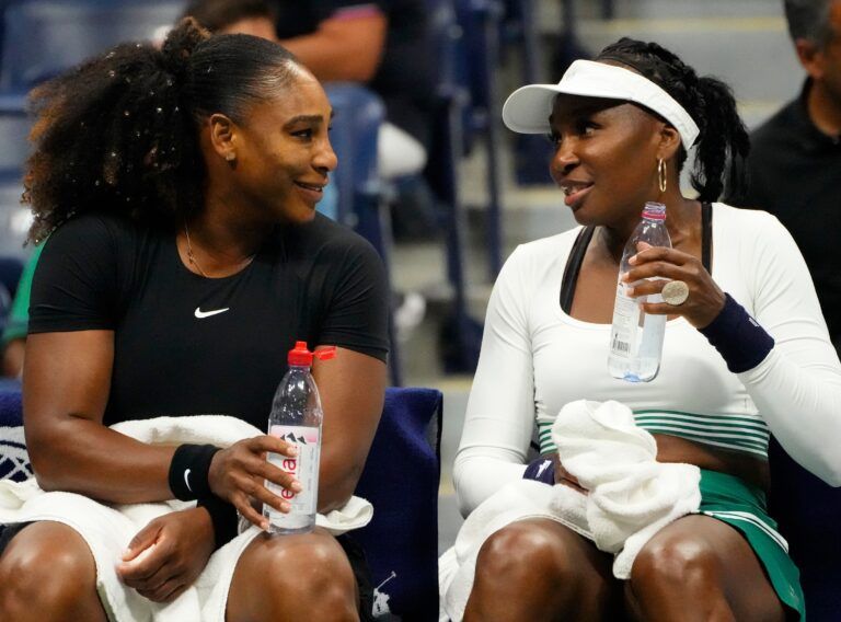 Serena Williams and Venus Williams of the USA on a change of ends as they play Lucie Hradecka and Linda Noskova of the Czech Republic in in women's doubles on day four of the 2022 U.S. Open tennis tournament at USTA Billie Jean King National Tennis Center.