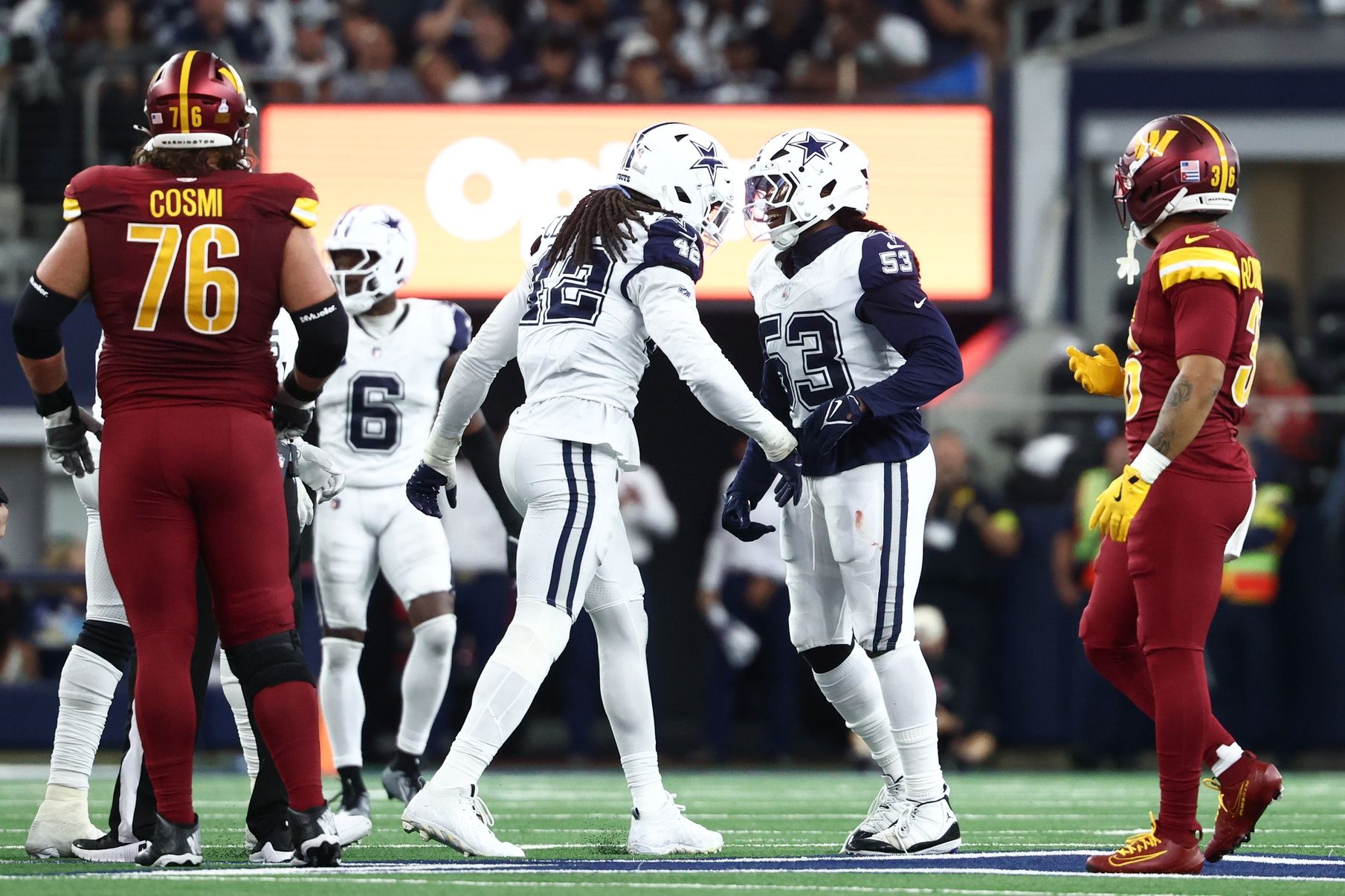 Dallas Cowboys outside linebacker Jadeveon Clowney (42) and defensive end James Houston (53) celebrate after a sack against the Washington Commanders during the fourth quarter of the game at AT&T Stadium.