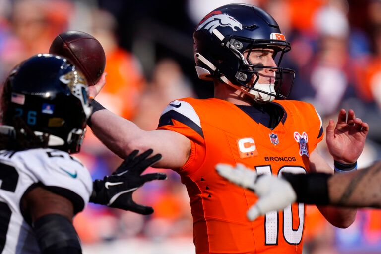 Denver Broncos quarterback Bo Nix (10) drops back to pass against the Jacksonville Jaguars during the first half  at Empower Field at Mile High.