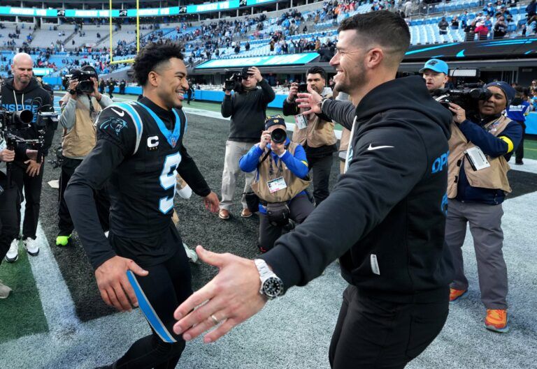 Carolina Panthers head coach Dave Canales celebrates with quarterback Bryce Young (9) after a game against the Tampa Bay Buccaneers at Bank of America Stadium.