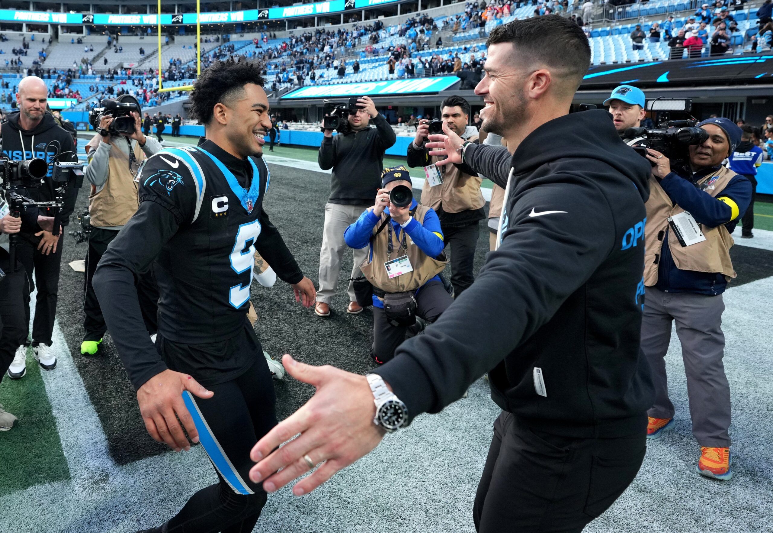 Carolina Panthers head coach Dave Canales celebrates with quarterback Bryce Young (9) after a game against the Tampa Bay Buccaneers at Bank of America Stadium.