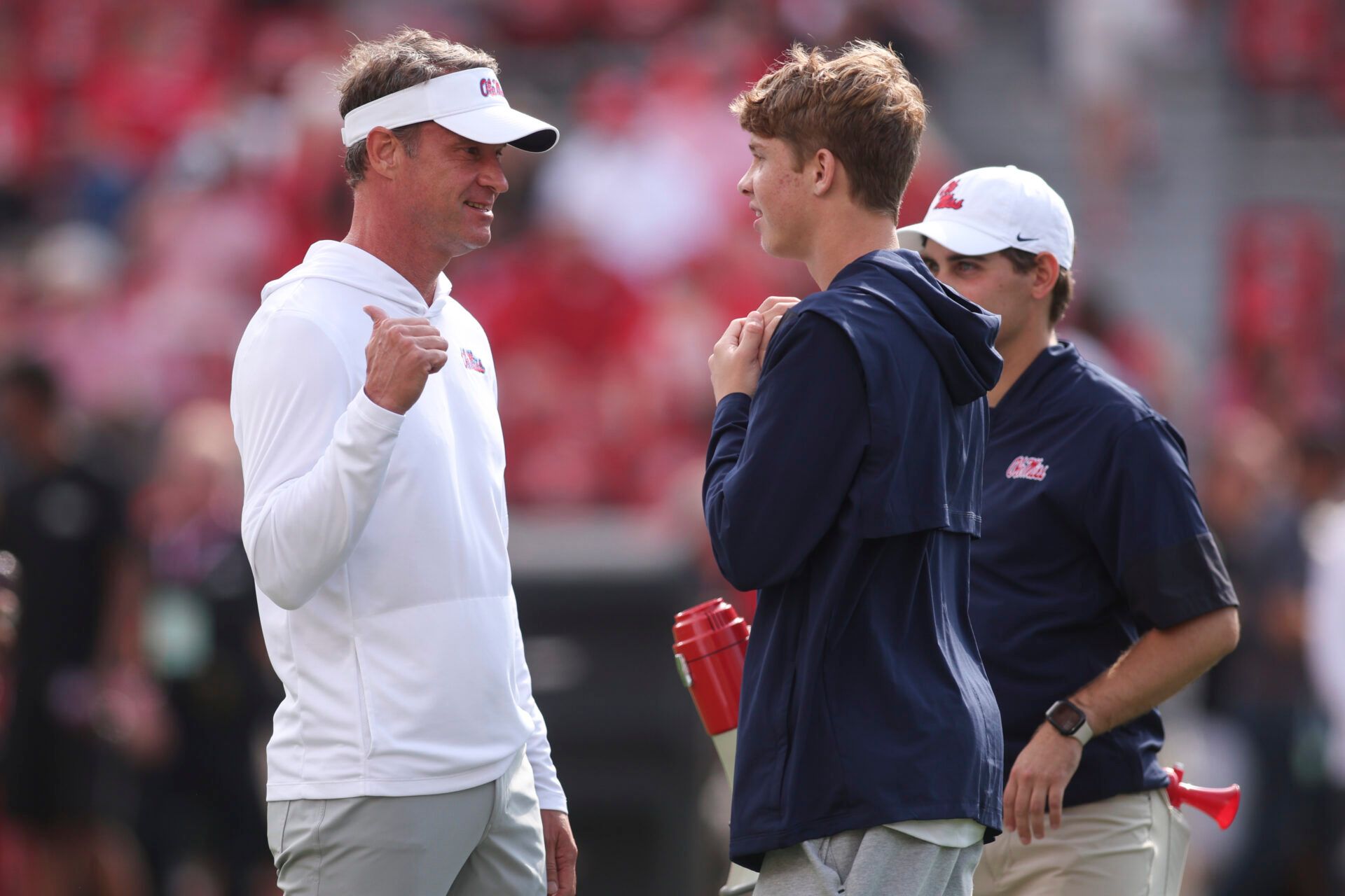 Mississippi Rebels head coach Lane Kiffin talks with his so Knox Kiffin prior to the game against the Georgia Bulldogs at Sanford Stadium.