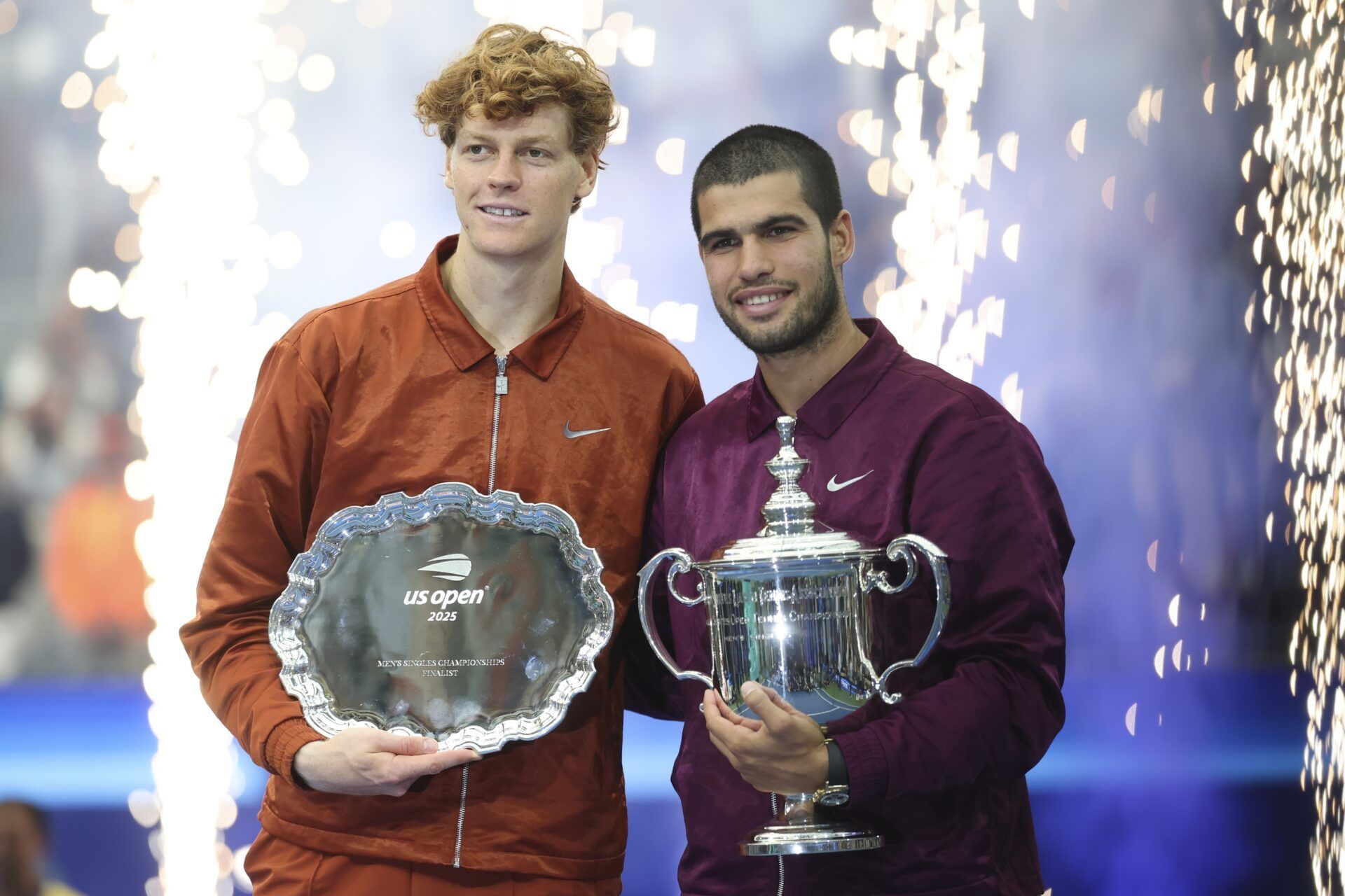 Carlos Alcaraz (ESP) and Jannik Sinner (ITA) pose with their trophies after the final of mens singles at Billie Jean King National Tennis Center.