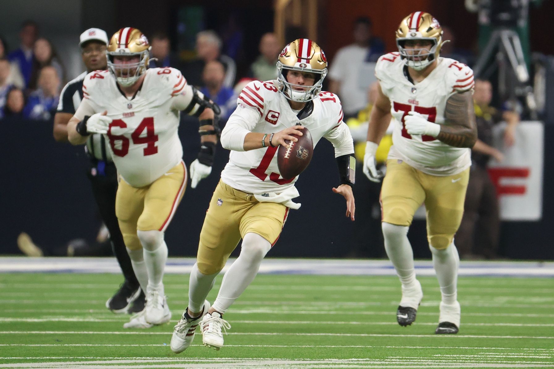 San Francisco 49ers quarterback Brock Purdy (13) scrambles with the ball against the Indianapolis Colts in the second quarter of the game at Lucas Oil Stadium.