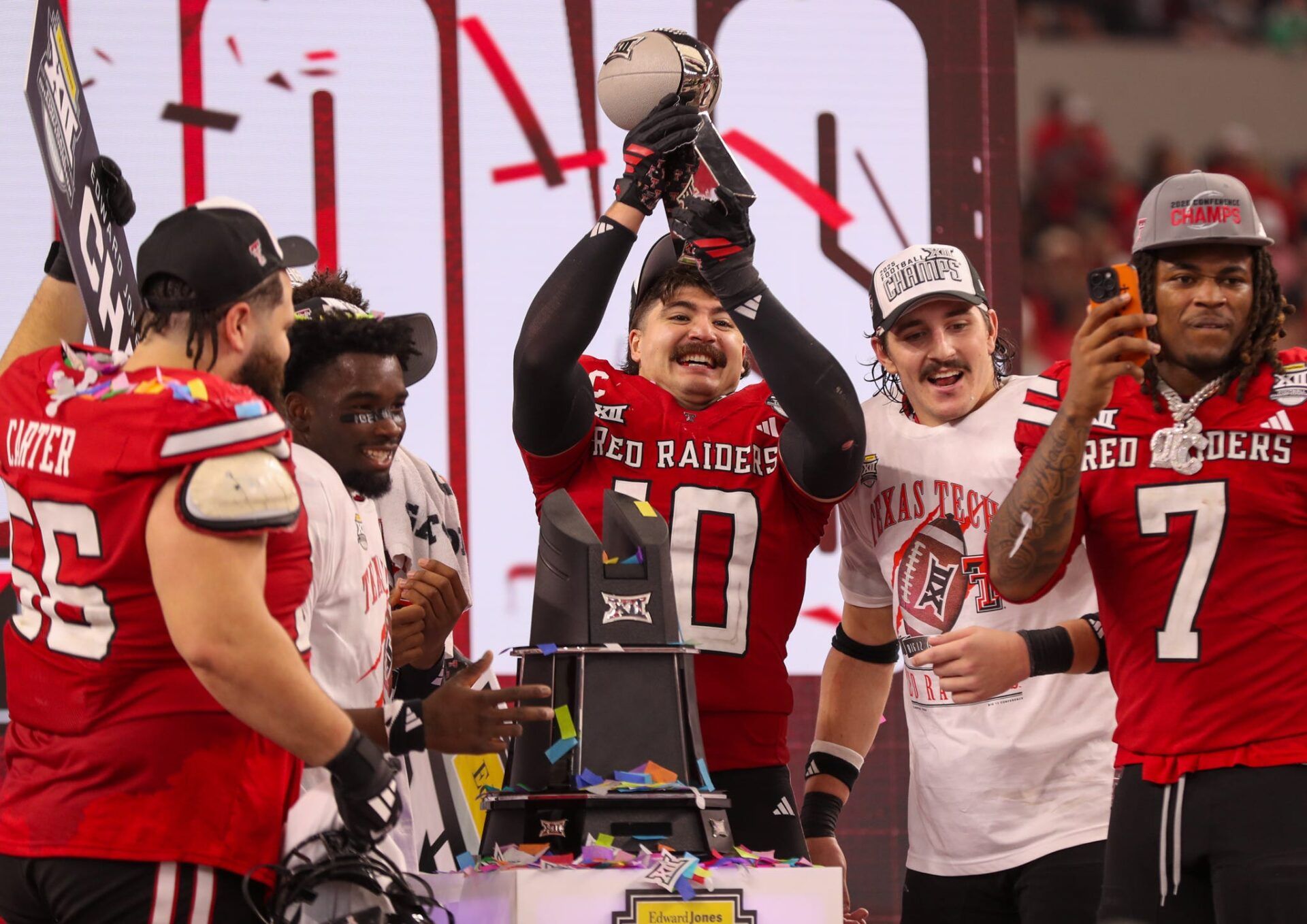 Jacob Rodriguez lifts the trophy after Texas Tech defeated BYU in the Big 12 Conference championship game, Saturday, Nov. 6, 2025, at AT&T Stadium in Arlington.