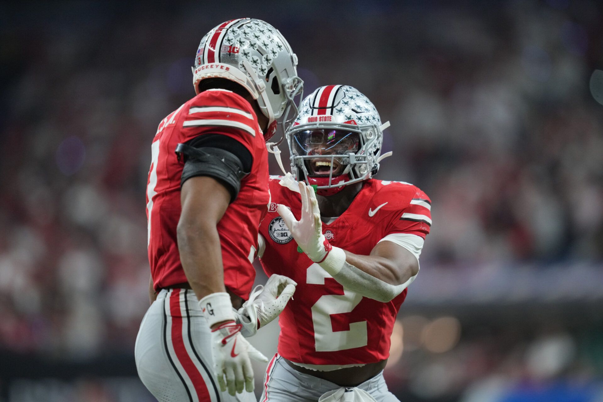 Ohio State Buckeyes safety Caleb Downs (2) and cornerback Lorenzo Styles Jr. (3) react in the first half against the Indiana Hoosiers during the 2025 Big Ten championship game at Lucas Oil Stadium.