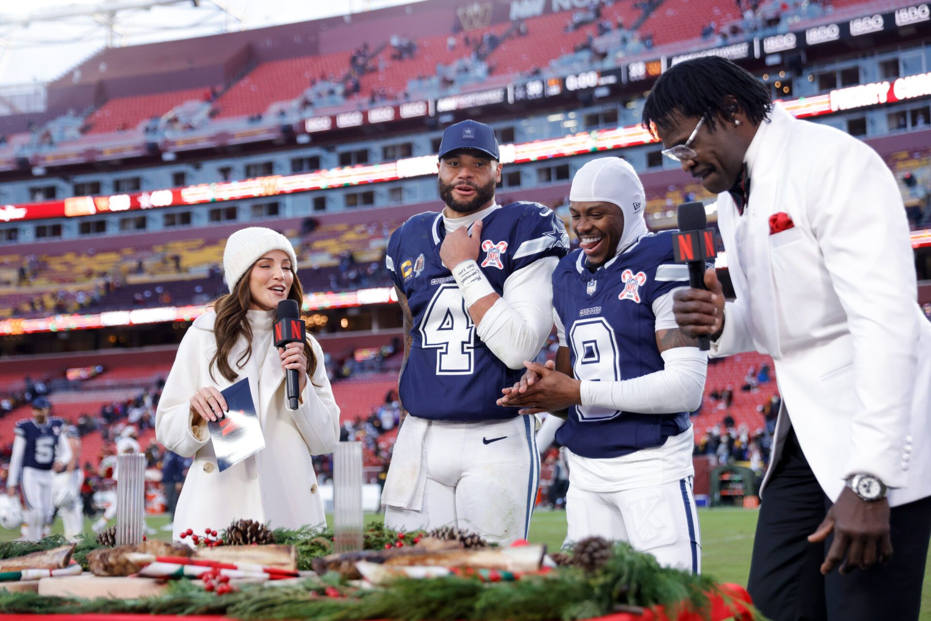 Dallas Cowboys quarterback Dak Prescott (4) and wide receiver Kavontae Turpin (9) are interviewed by Kay Adams and Michael Irvin after the game against the Washington Commanders at Northwest Stadium.