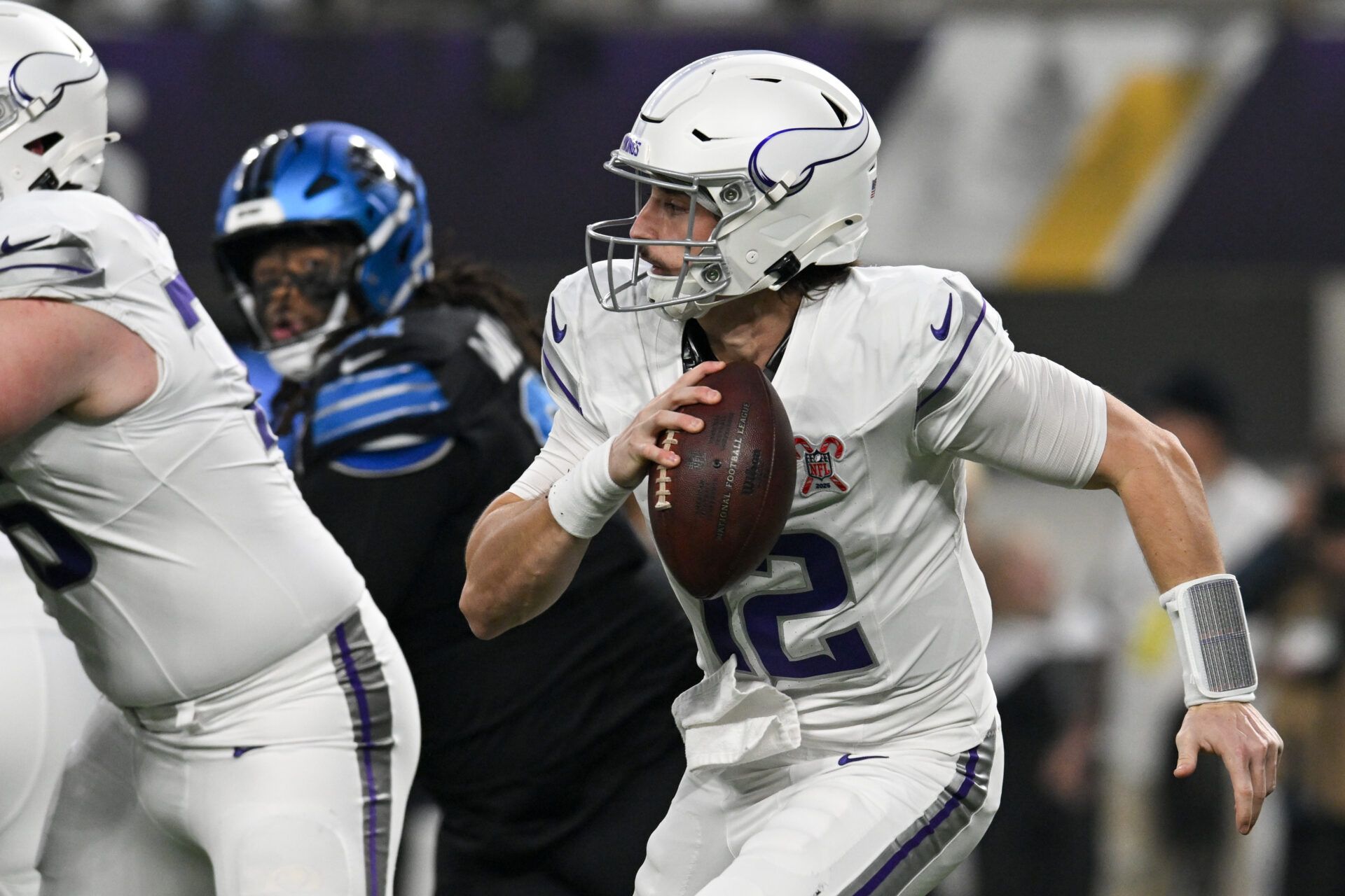 Minnesota Vikings quarterback Max Brosmer (12) scrambles with the ball against the Detroit Lions in the first quarter at U.S. Bank Stadium.
