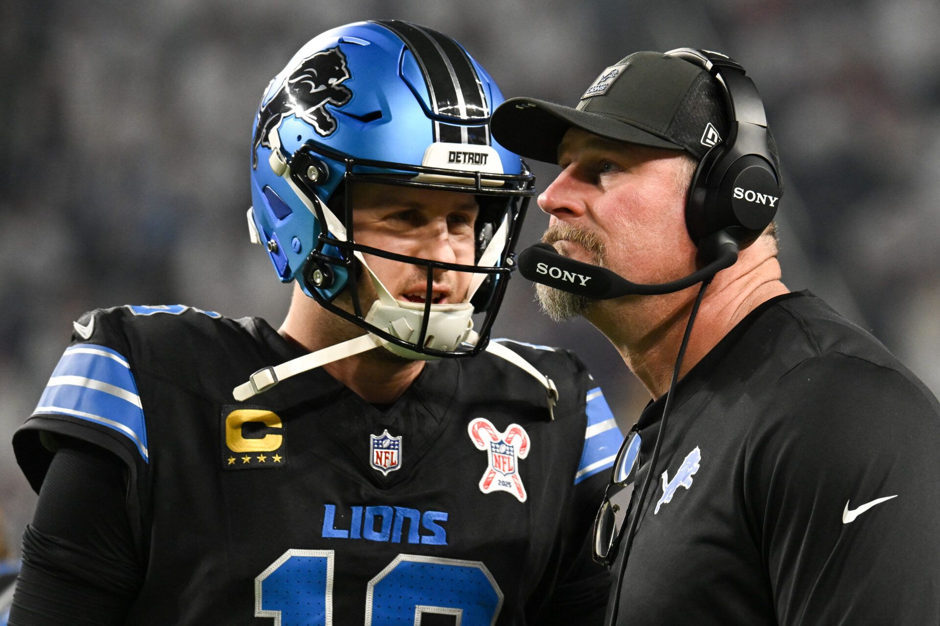 Detroit Lions quarterback Jared Goff (16) speaks with head coach Dan Campbell in the second quarter against the Minnesota Vikings at U.S. Bank Stadium.