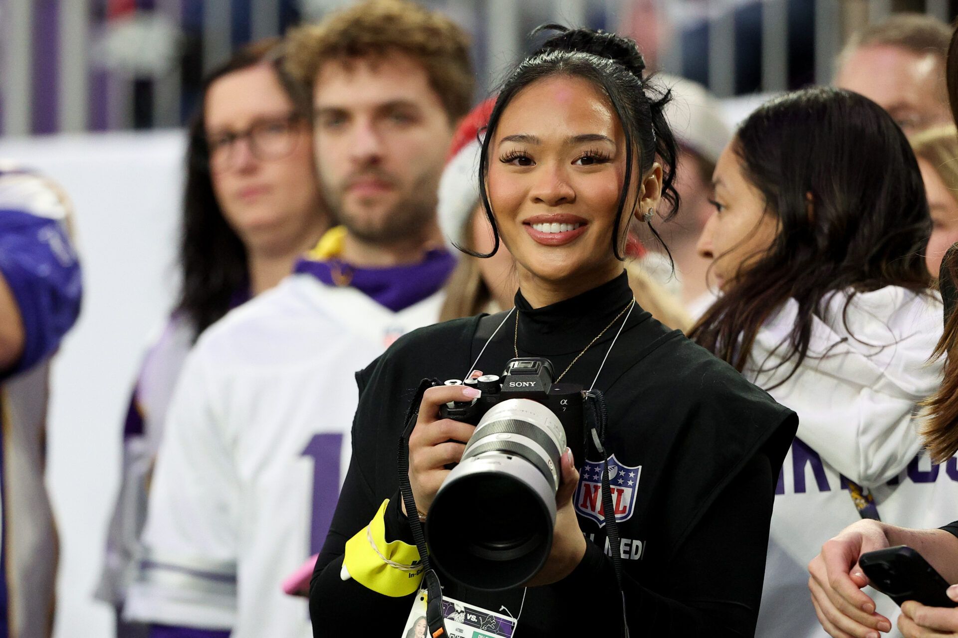 Suni Lee, gymnast for the Uniteded States, is seen on the sidelines during warmups before the game between the Minnesota Vikings and the Detroit Lions at U.S. Bank Stadium.