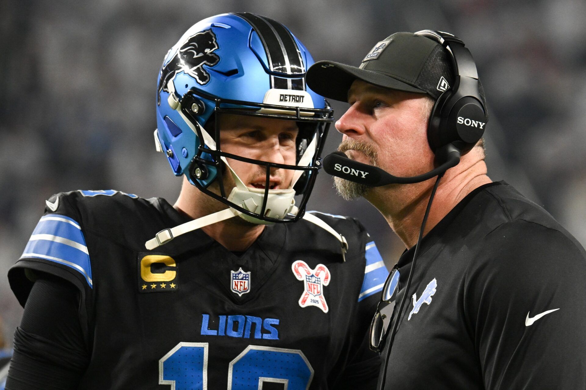 Detroit Lions quarterback Jared Goff (16) speaks with head coach Dan Campbell in the second quarter against the Minnesota Vikings at U.S. Bank Stadium.