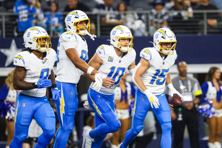 Los Angeles Chargers wide receiver Ladd McConkey (15) returns to the bench with running back Omarion Hampton (8), tight end Will Dissly (89) and quarterback Justin Herbert (10) after catching a touchdown pass from Herbert against the Dallas Cowboys during the second quarter at AT&T Stadium.