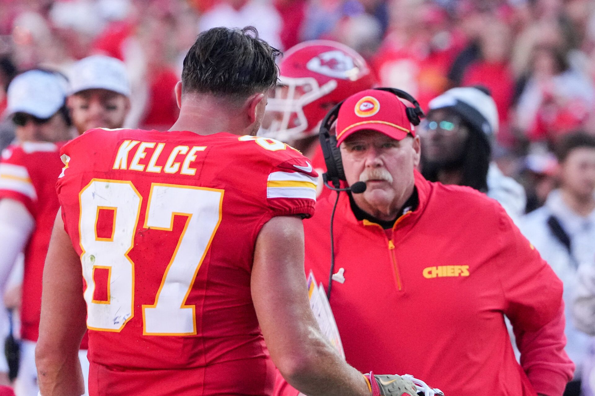 Kansas City Chiefs tight end Travis Kelce (87) talks with head coach Andy Reid against the Denver Broncos during the second half at GEHA Field at Arrowhead Stadium.