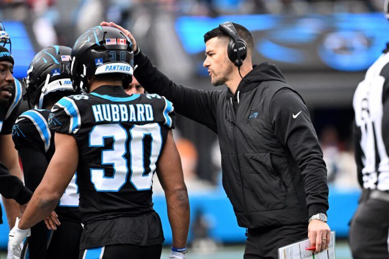 Carolina Panthers head coach Dave Canales with running back Chuba Hubbard (30) in the third quarter at Bank of America Stadium.