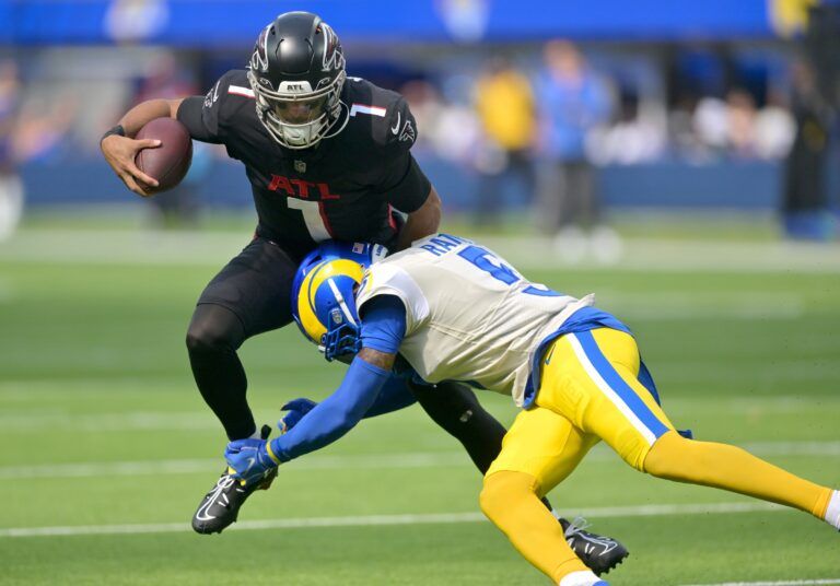Atlanta Falcons quarterback Marcus Mariota (1) is sacked by Los Angeles Rams cornerback Jalen Ramsey (5) in the second half at SoFi Stadium.