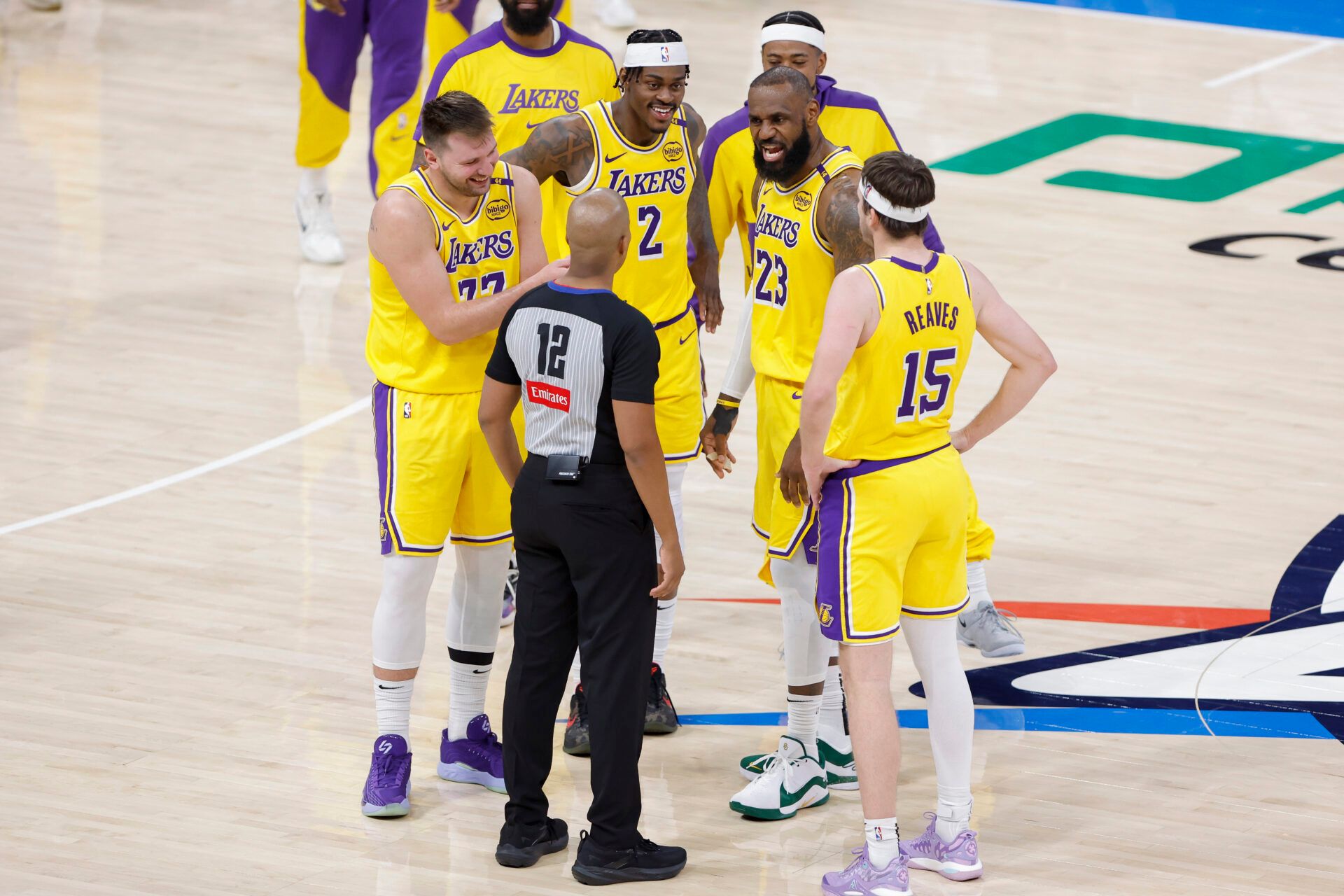 Los Angeles Lakers guard Luka Doncic (77), forward Jarred Vanderbilt (2), forward LeBron James (23), and guard Austin Reaves (15) talk to an official during a time out in the second half of a game against the Oklahoma City Thunder at Paycom Center.