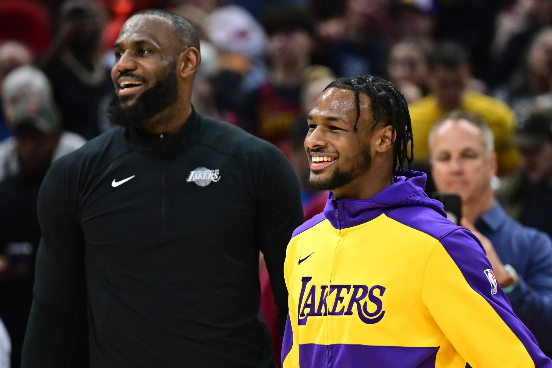 Los Angeles Lakers guard Bronny James, right, and forward LeBron James warm up before the game between the Cleveland Cavaliers and the Lakers at Rocket Mortgage FieldHouse.