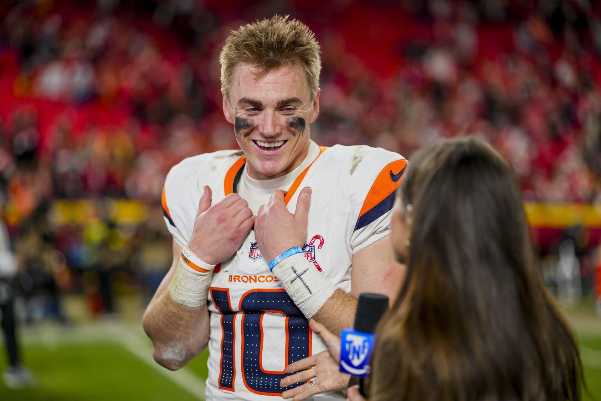 Denver Broncos quarterback Bo Nix (10) gives an interview after the game at GEHA Field at Arrowhead Stadium.