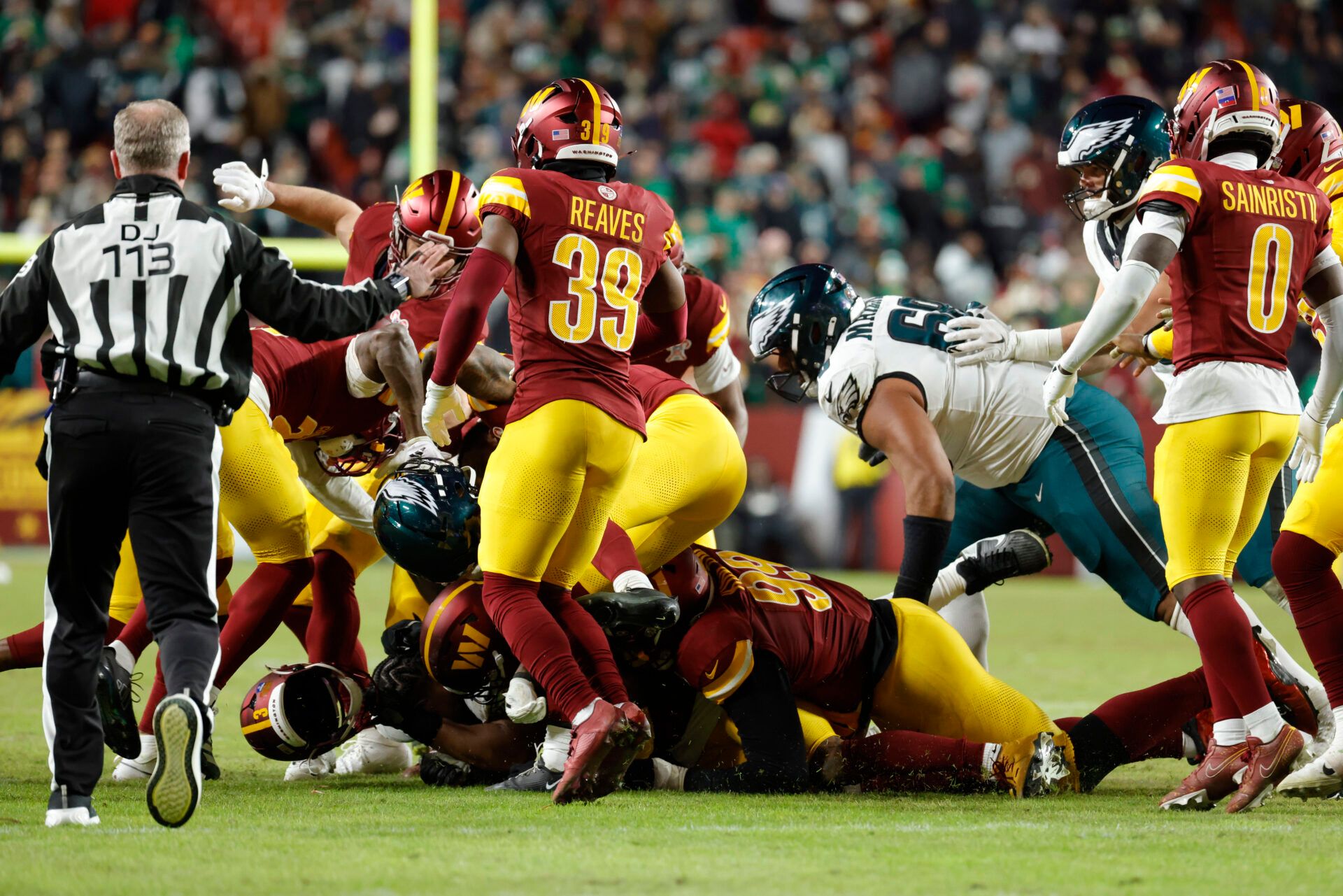 Washington Commanders and Philadelphia Eagles players fight on the field during the second half at Northwest Stadium.