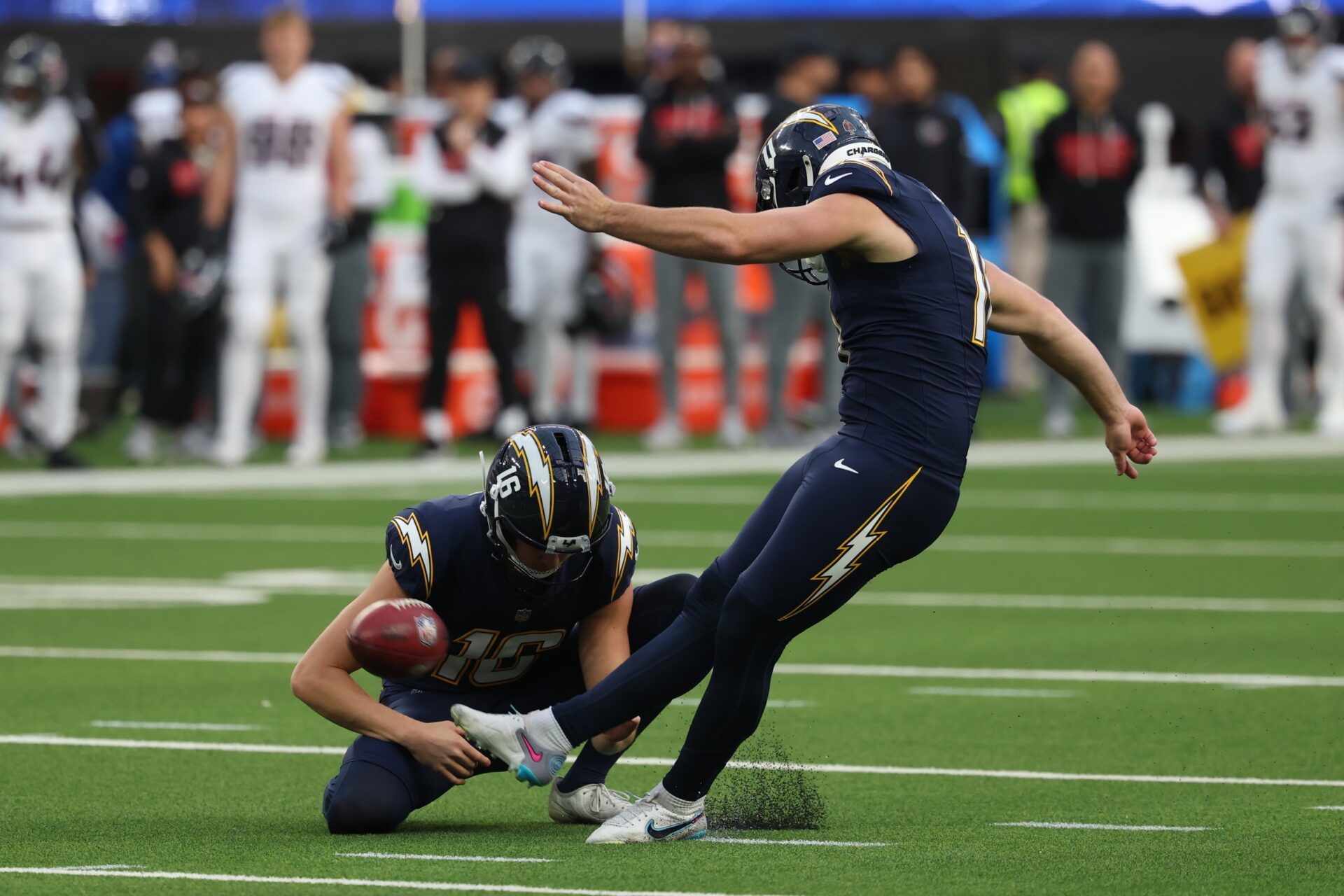 Los Angeles Chargers place kicker Cameron Dicker (11) kicks a field goal out of the hold by punter JK Scott (16) against the Houston Texans during the first half at SoFi Stadium.