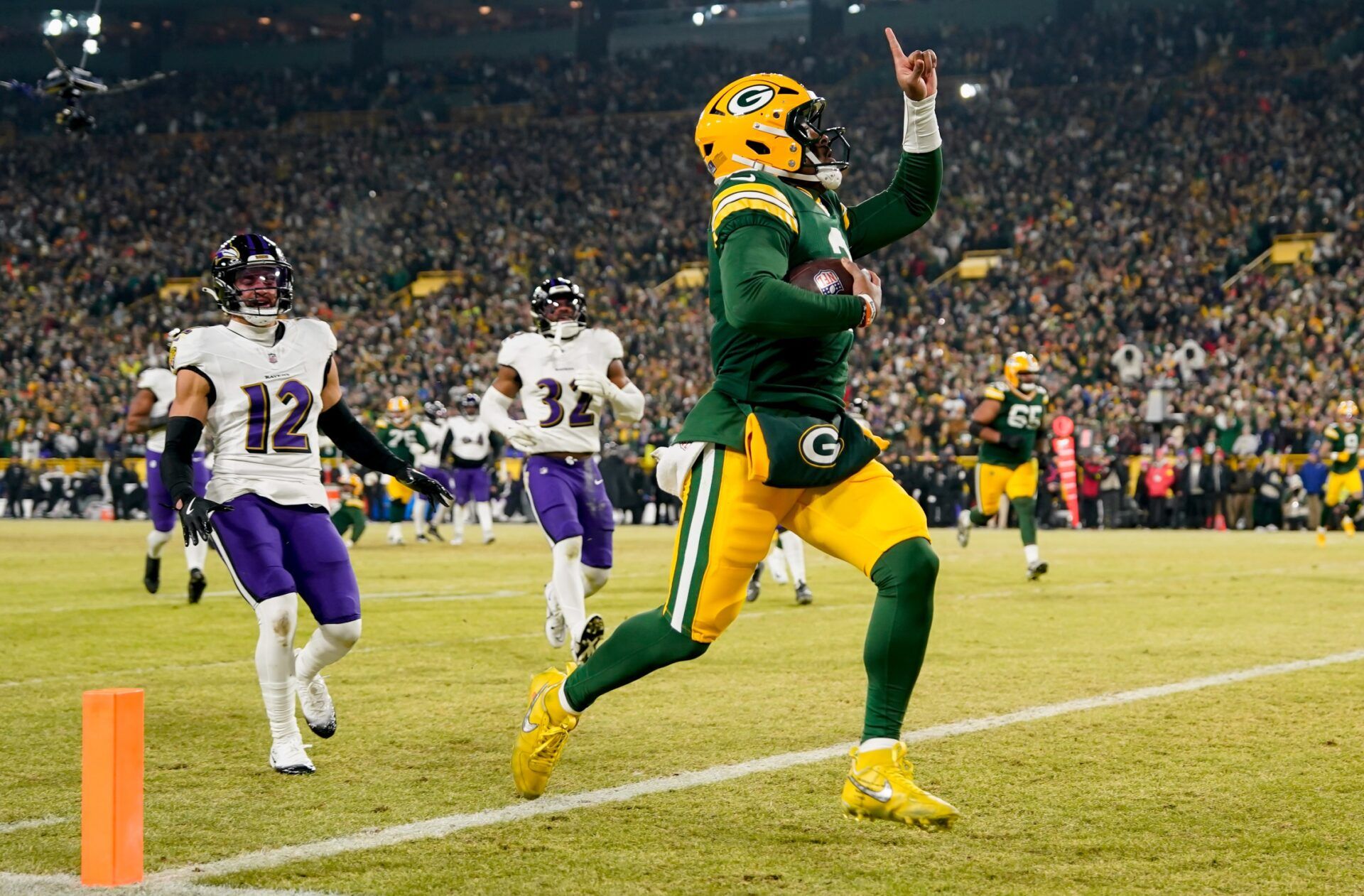 Green Bay Packers quarterback Malik Willis (2) runs for a touchdown during the second quarter against the Baltimore Ravens at Lambeau Field.