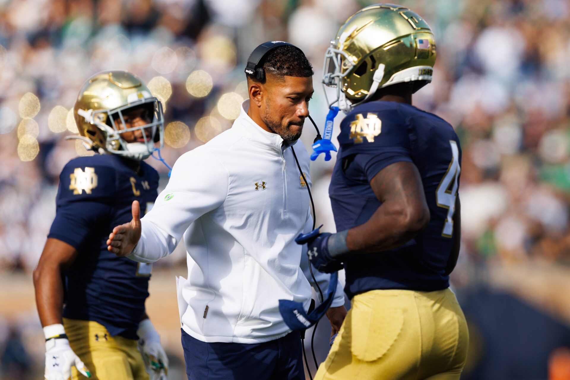 Notre Dame head coach Marcus Freeman, center, slaps hands with running back Jeremiyah Love (4) after a Love touchdown in the first half of a NCAA football game against NC State at Notre Dame Stadium on Saturday, Oct. 11, 2025, in South Bend.