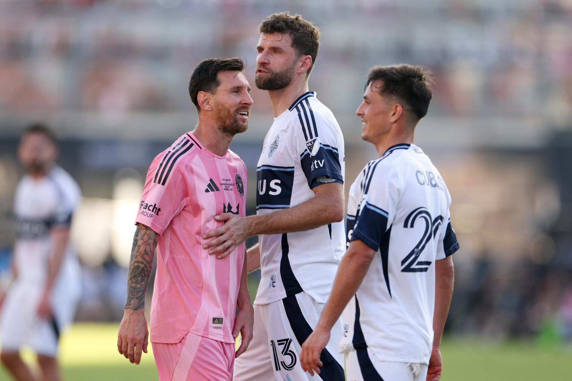 Inter Miami forward Lionel Messi (10) speaks with Vancouver Whitecaps FC forward Thomas Muller (13) and midfielder Andres Cubas (20) in the second half during the 2025 MLS Cup at Chase Stadium.