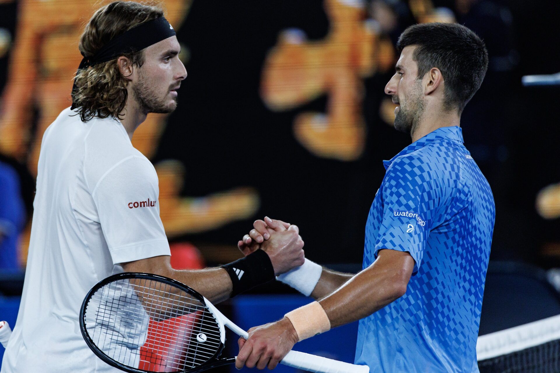 Novak Djokovic of Serbia shakes hands with Stefanos Tsitsipas of Greece after beating him in the men's final on day fourteen of the 2023 Australian Open tennis tournament at Melbourne Park.