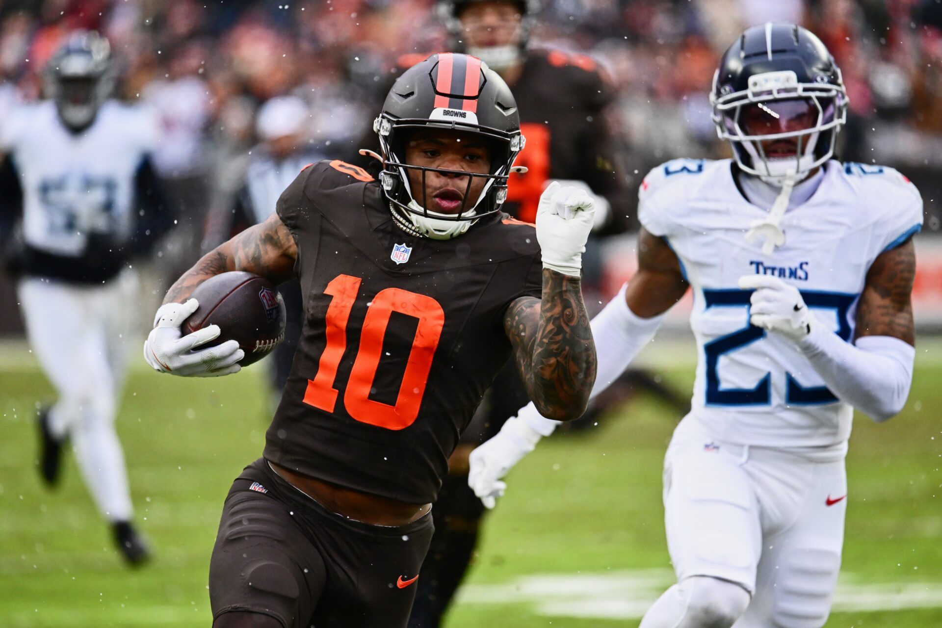 Cleveland Browns running back Quinshon Judkins (10) runs with the ball against Tennessee Titans safety Kevin Winston Jr. (23) during the first quarter at Huntington Bank Field.