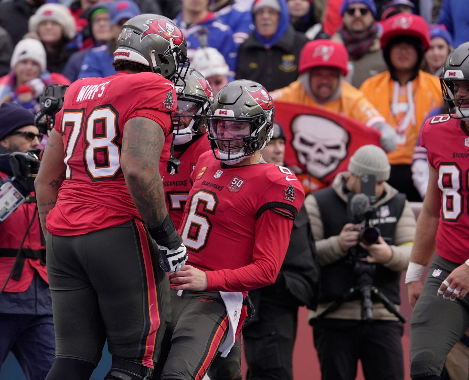 Tampa Bay Buccaneers quarterback Baker Mayfield celebrates with teammates including Tampa Bay Buccaneers offensive tackle Tristan Wirfs after the team scored a touchdown during first half action against the Tampa Bay Buccaneers on Nov 16, 2025 at Highmark Stadium in Orchard Park.