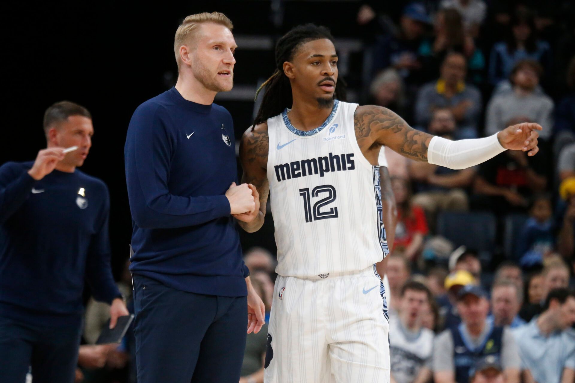 Memphis Grizzlies head coach Tuomas Iisalo talks with guard Ja Morant (12) during the fourth quarter against the Milwaukee Bucks at FedExForum.