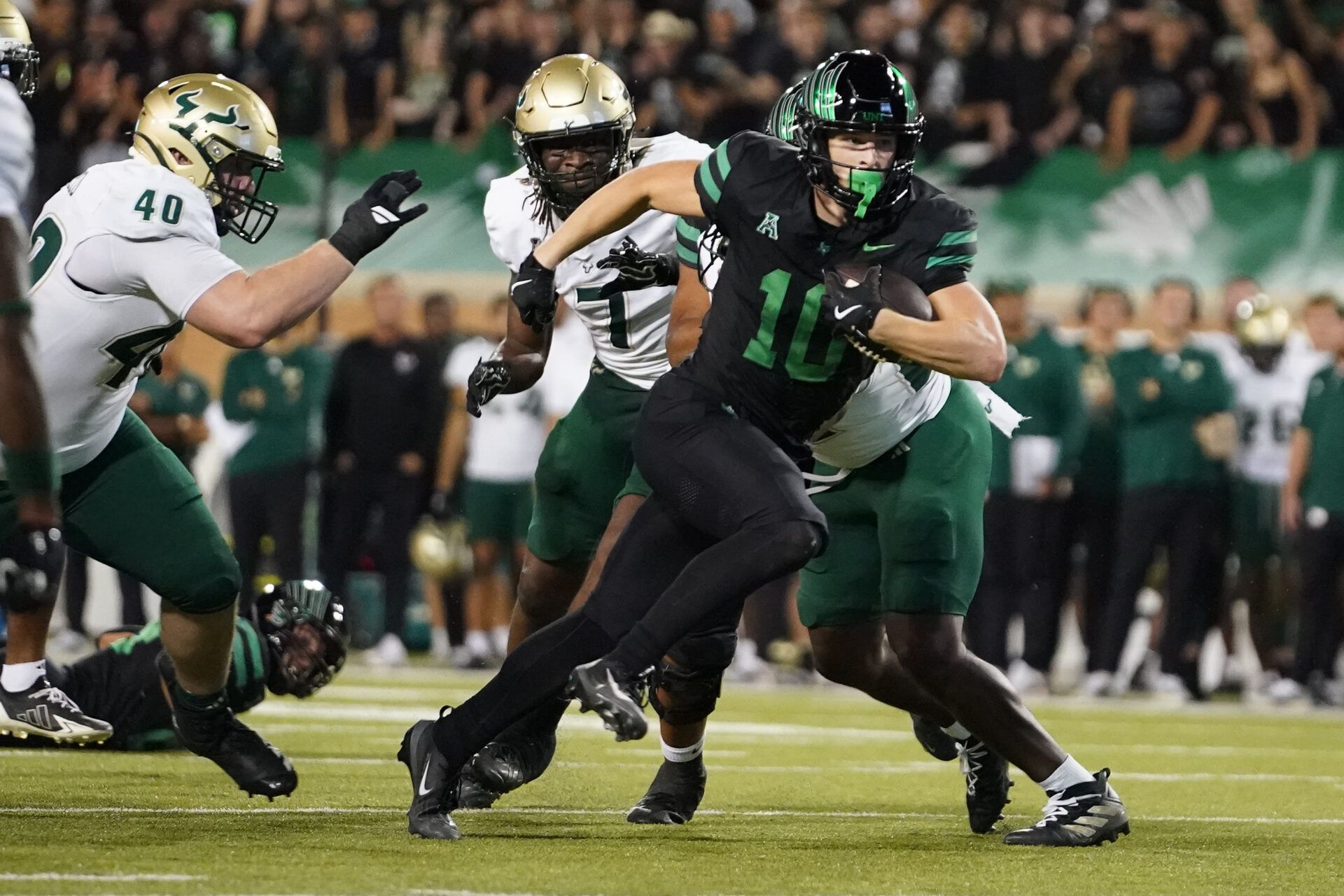 North Texas Mean Green wide receiver Wyatt Young (10) carrie the ball for a touchdown against the South Florida Bulls during the first half of a game at DATCU Stadium.