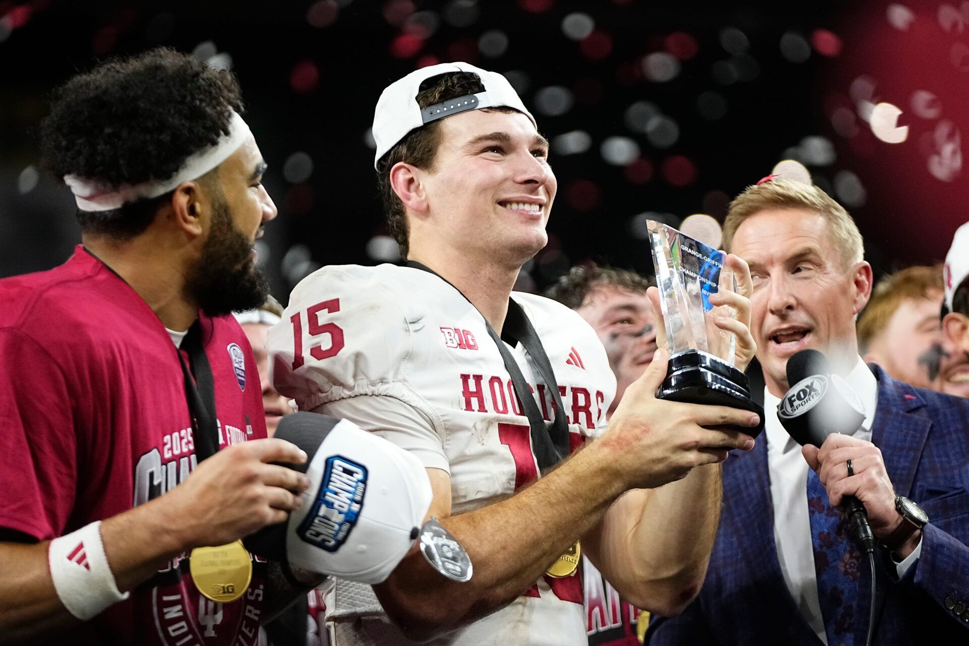 Indiana Hoosiers quarterback Fernando Mendoza (15) celebrates with the MVP trophy following the Big Ten Conference championship game against the Ohio State Buckeyes at Lucas Oil Stadium in Indianapolis on Dec. 6, 2025. Ohio State lost 13-10.