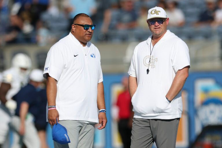 BYU Cougars head coach Kalani Sitake (left) speaks to Georgia Tech Yellow Jackets head coach Brent Key before the Pop-Tarts Bowl at Camping World Stadium.