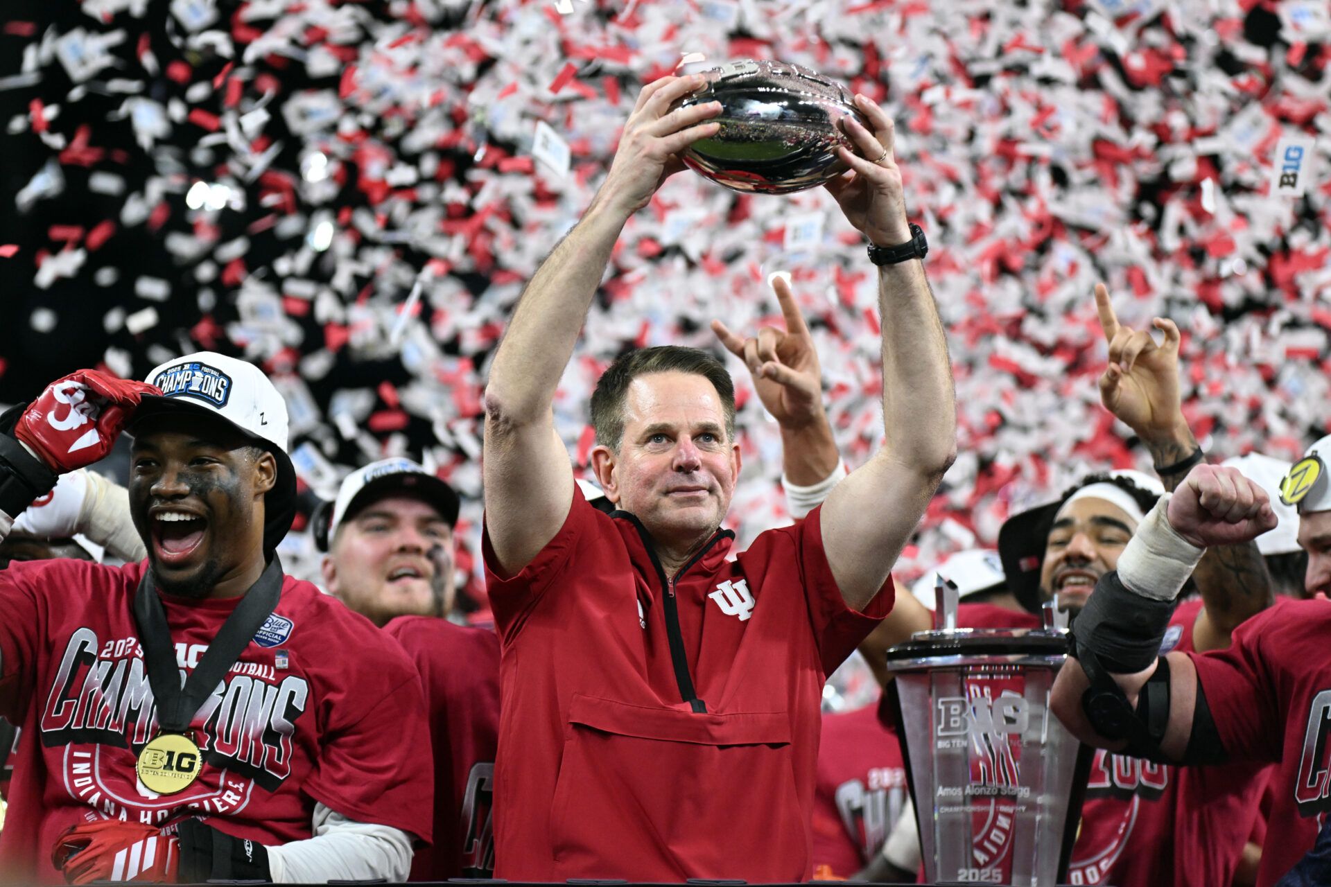 Indiana Hoosiers head coach Curt Cignetti celebrates with the trophy after defeating the Ohio State Buckeyes during the 2025 Big Ten championship game at Lucas Oil Stadium.