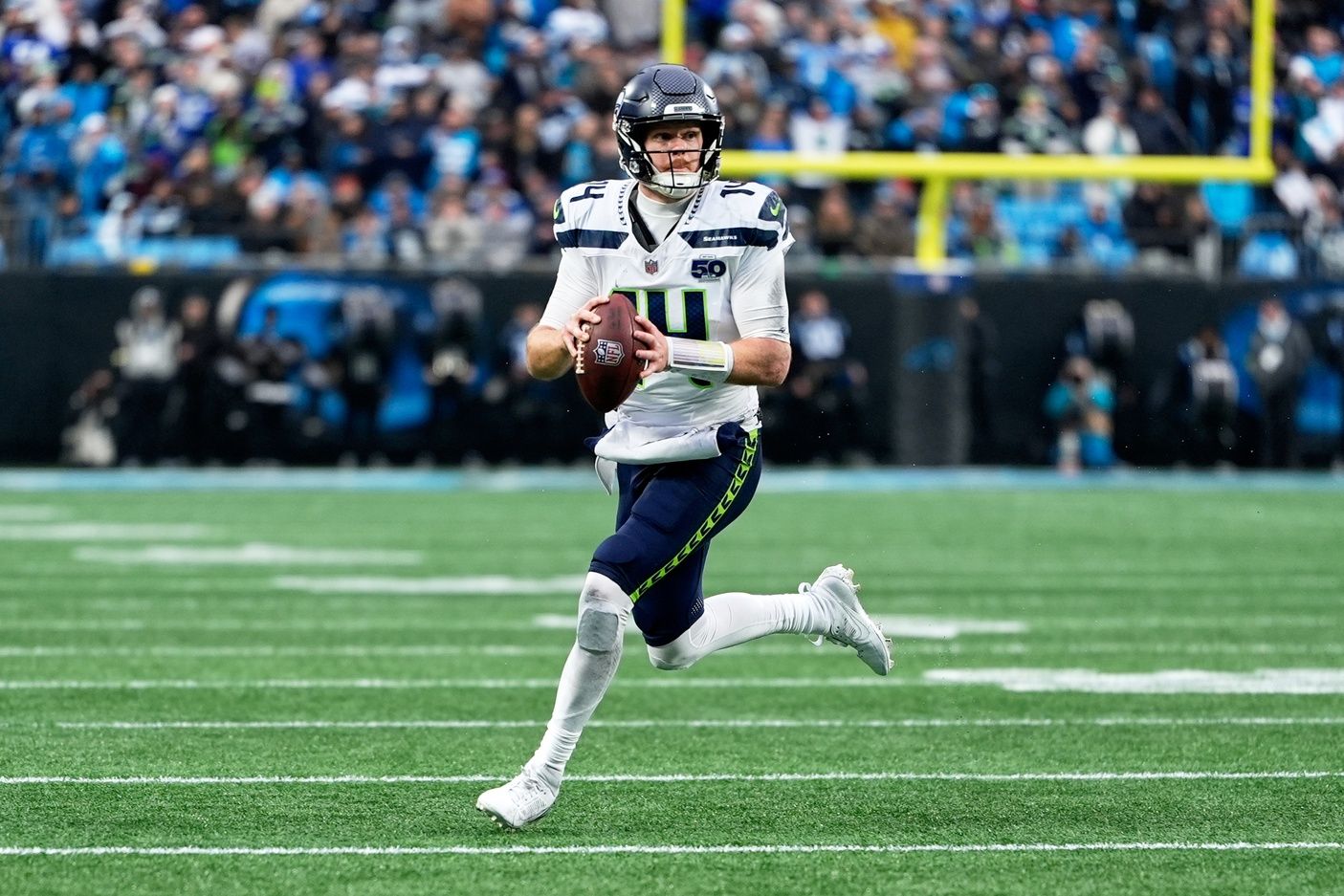 Seattle Seahawks quarterback Sam Darnold (14) looks to throw a pass while scrambling against the Carolina Panthers during the fourth quarter at Bank of America Stadium.