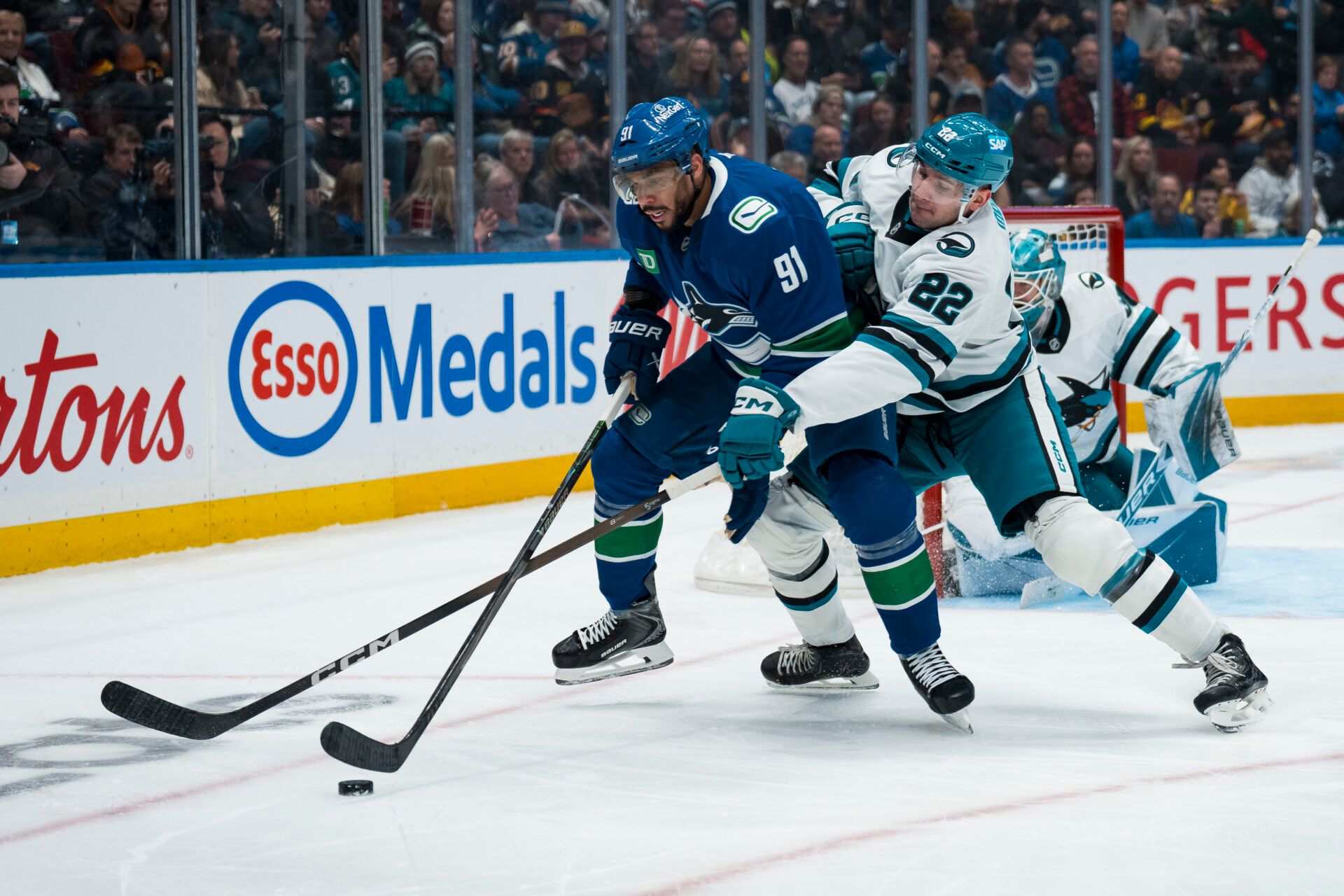 San Jose Sharks defenseman Vincent Iorio (22) battles with Vancouver Canucks forward Evander Kane (91) in the second period at Rogers Arena.
