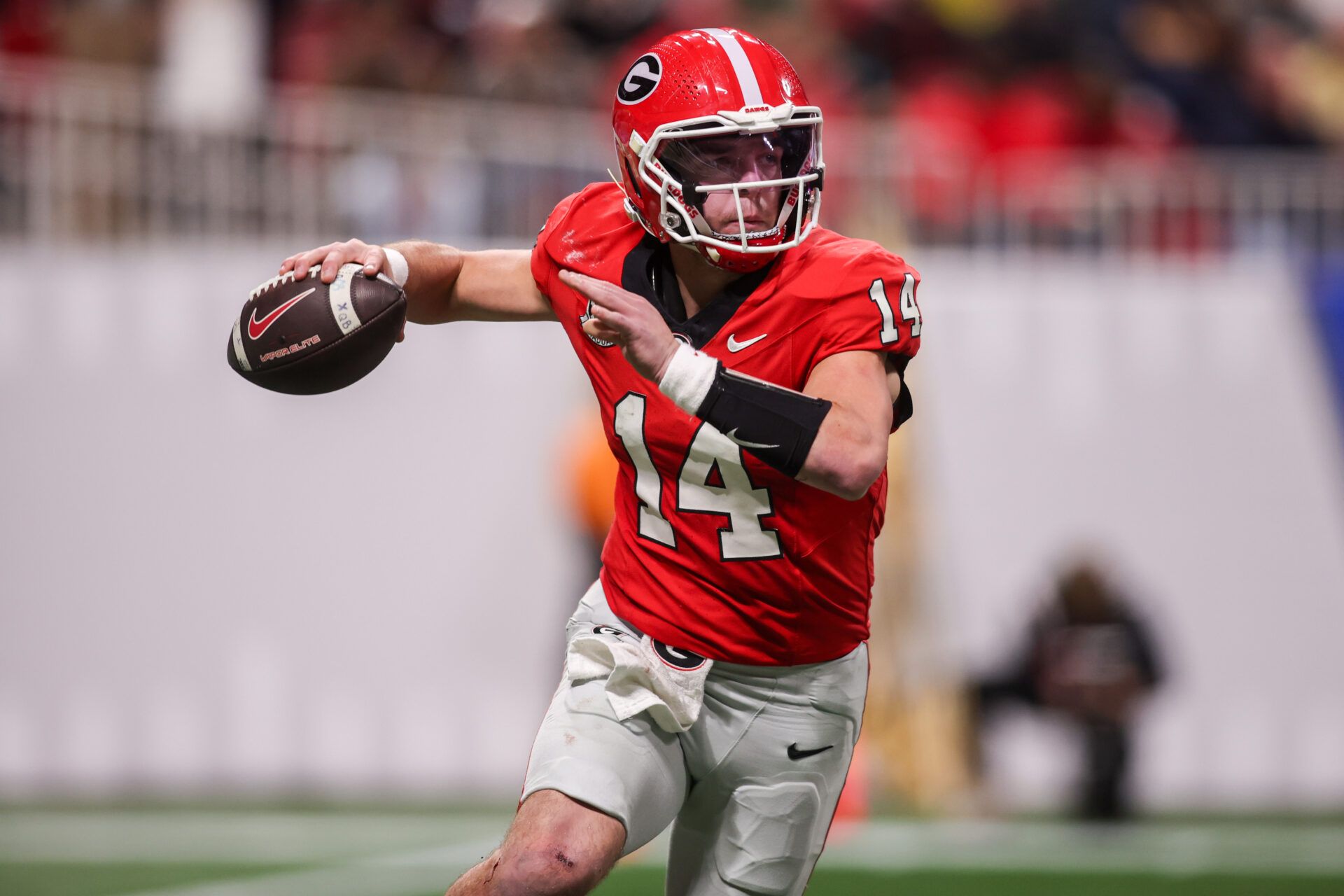 Georgia Bulldogs quarterback Gunner Stockton (14) throws a pass against the Georgia Tech Yellow Jackets in the third quarter at Mercedes-Benz Stadium.