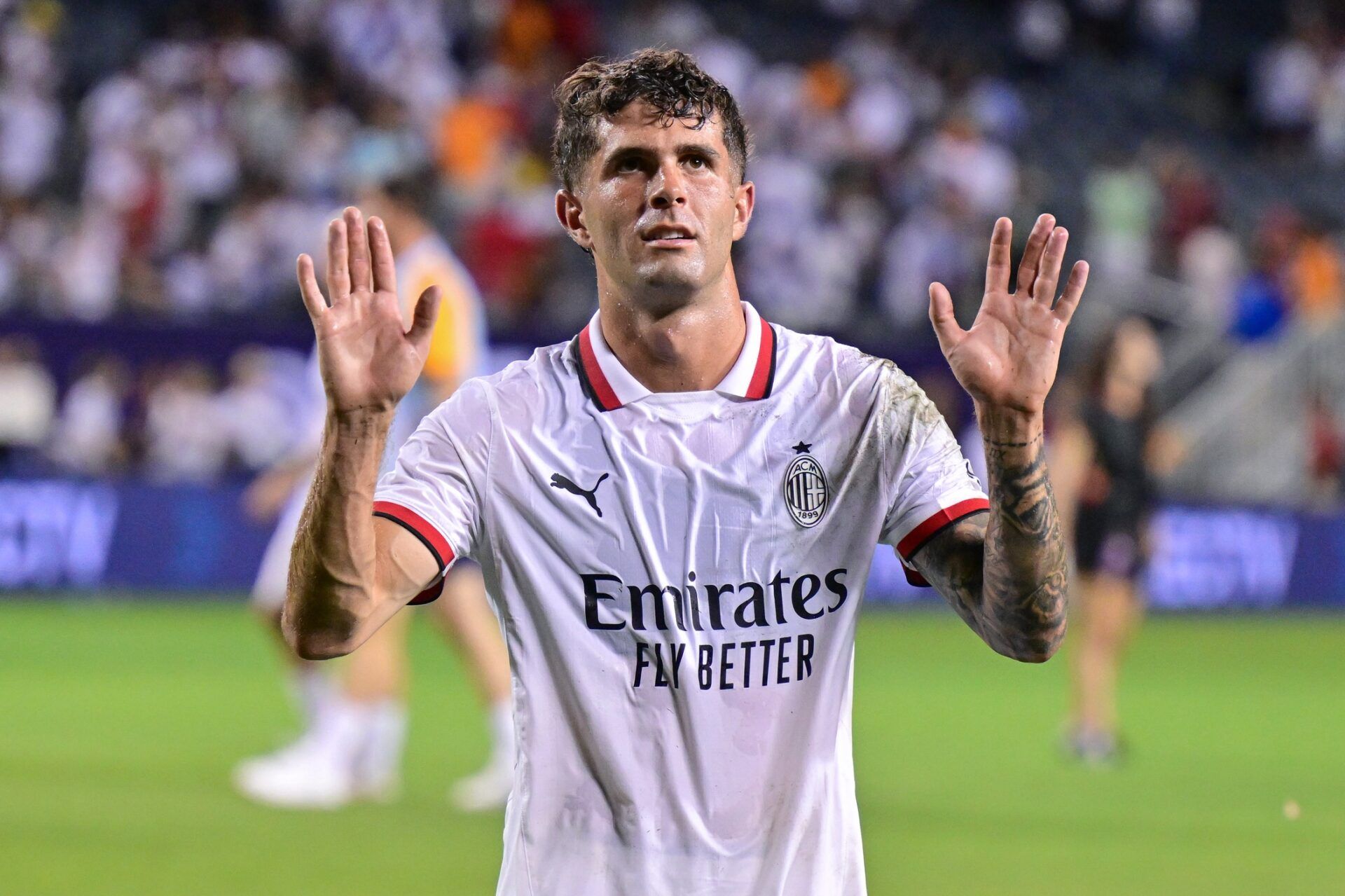 AC Milan midfielder Christian Pulisic (11) waves to fans after the game against Real Madrid at Soldier Field.