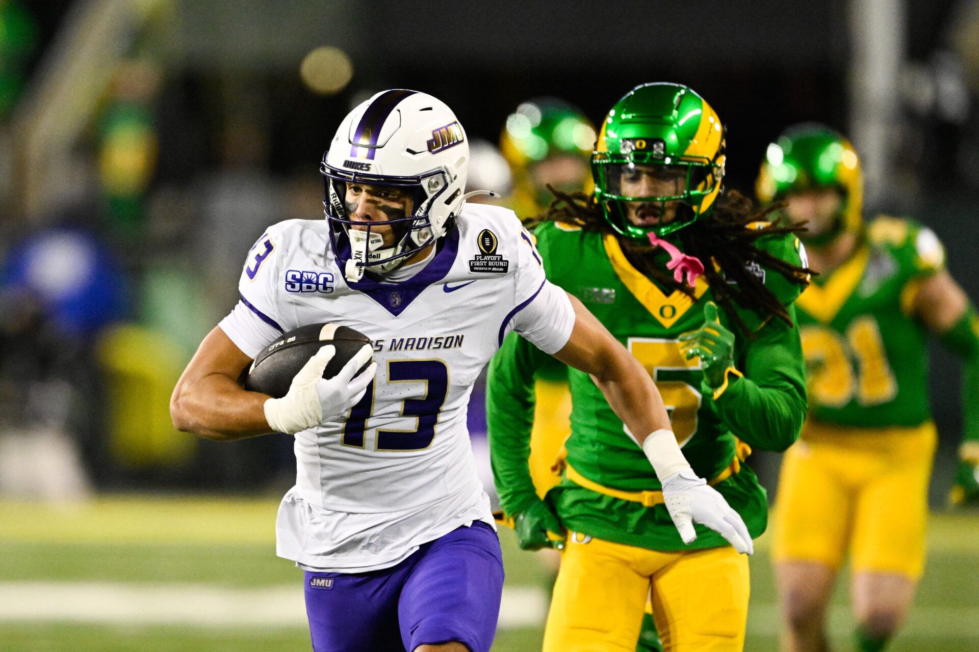 James Madison Dukes wide receiver Landon Ellis (13) runs after making a catch as Oregon Ducks defensive back Theran Johnson (5) defends during the second quarter at Autzen Stadium.