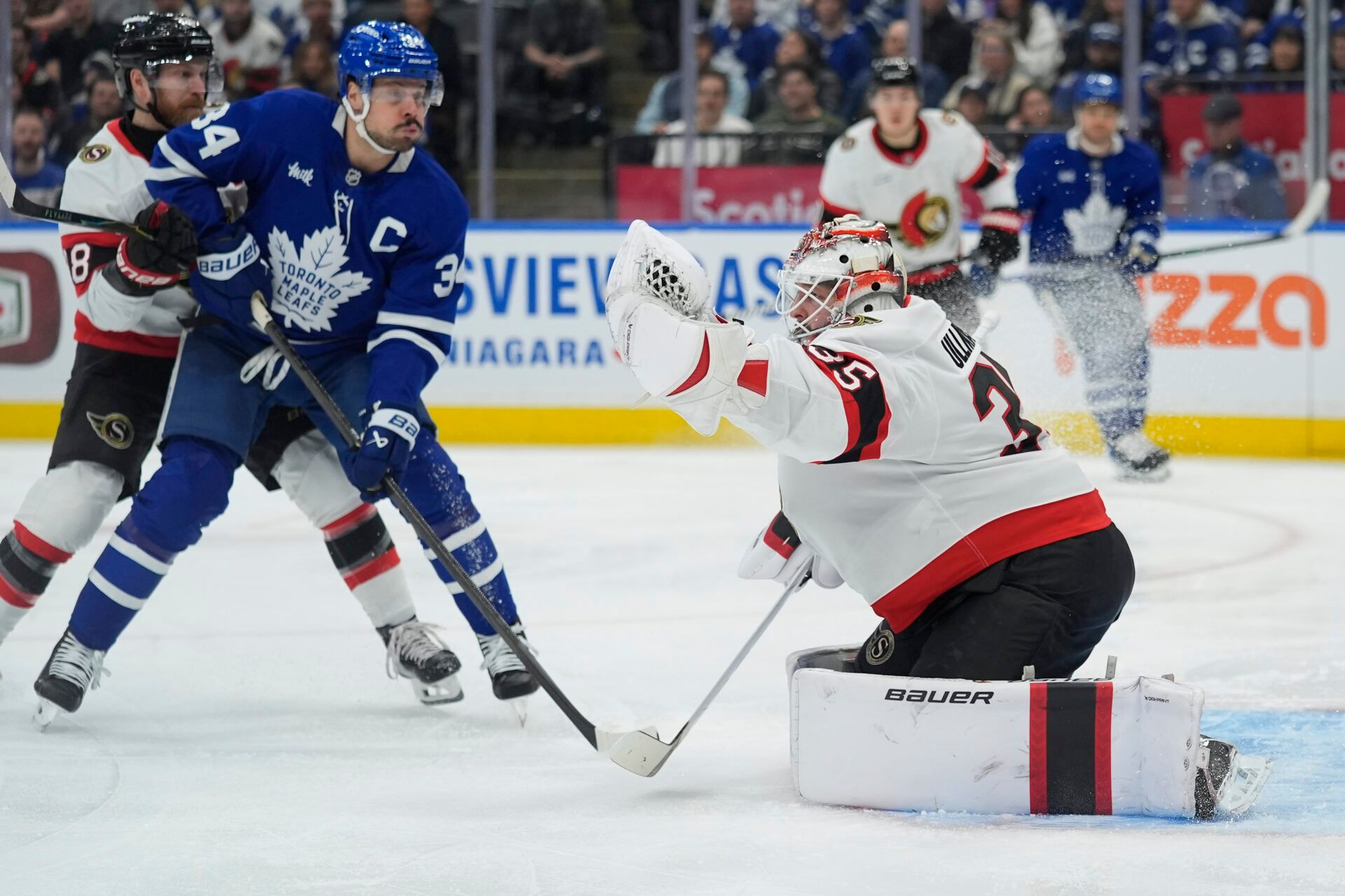 Ottawa Senators goaltender Linus Ullmark (35) makes a glove save as Toronto Maple Leafs forward Auston Matthews (34) closes in during the first period at Scotiabank Arena.