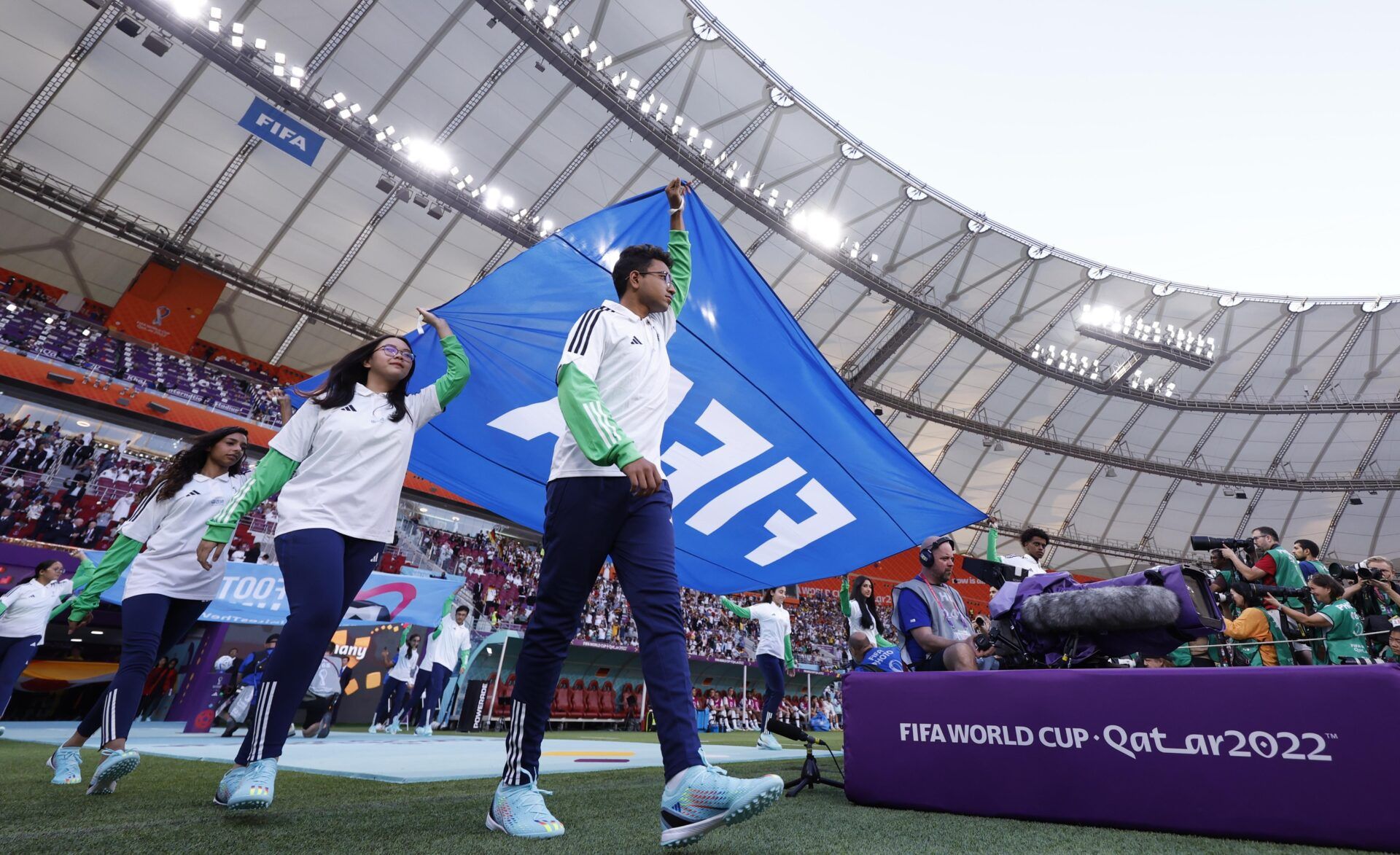 FIFA flags are brought out during a group stage match between Germany and Japan during the 2022 World Cup at Khalifa International Stadium.