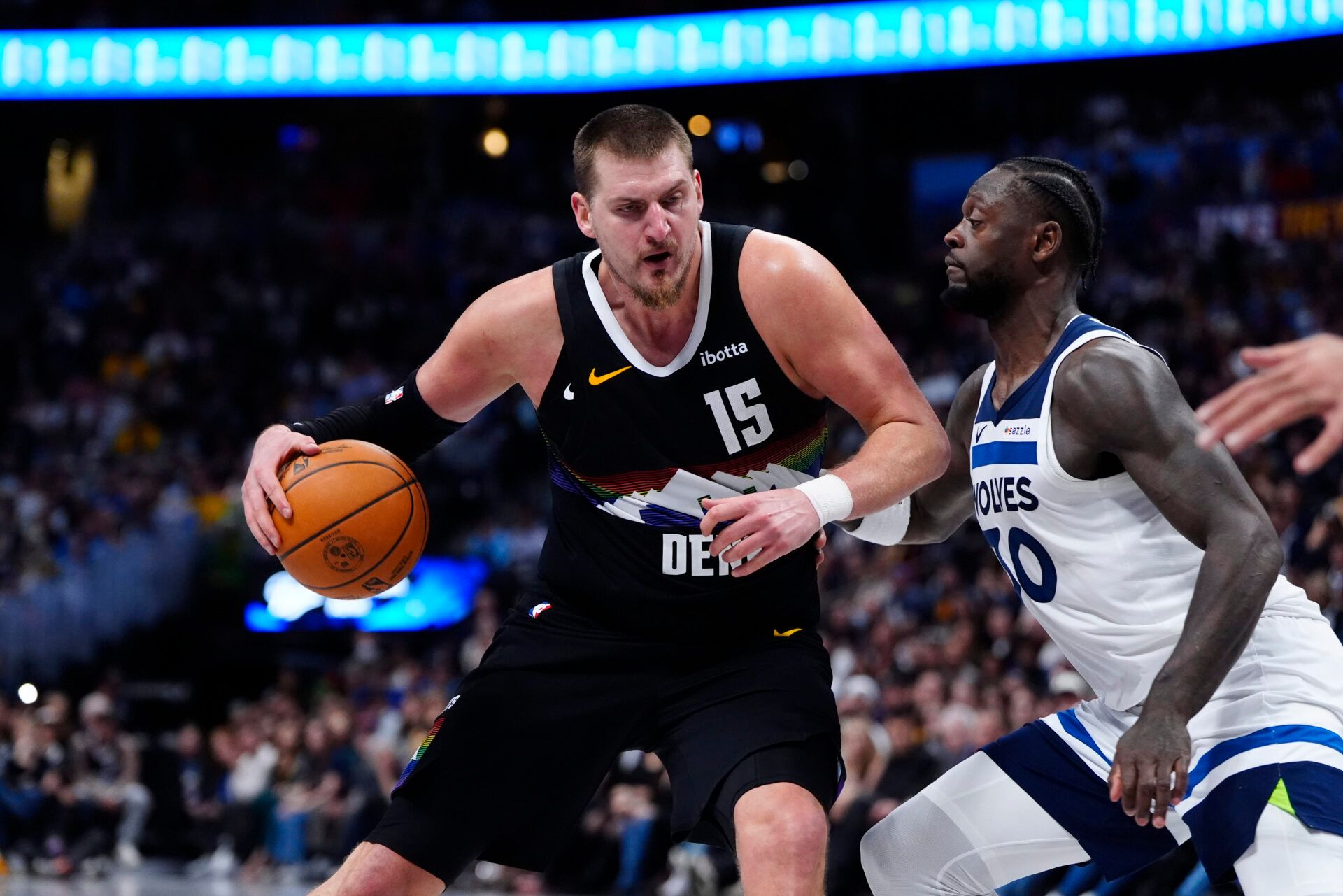 Minnesota Timberwolves forward Julius Randle (30) defends on Denver Nuggets center Nikola Jokic (15) at Ball Arena.