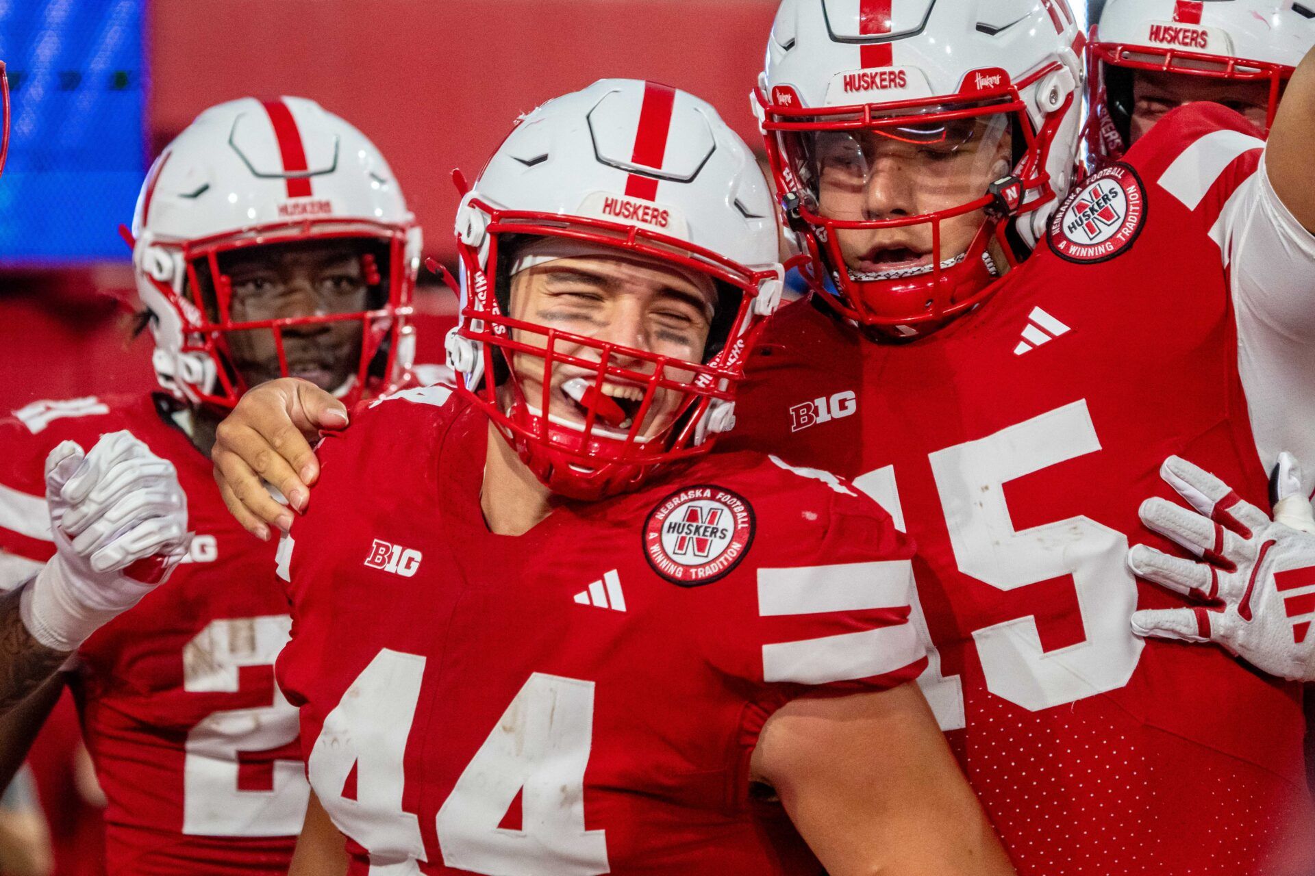 Nebraska Cornhuskers running back Emmett Johnson (21), tight end Luke Lindenmeyer (44) and quarterback Dylan Raiola (15) celebrate after a touchdown against the Akron Zips during the second quarter at Memorial Stadium.