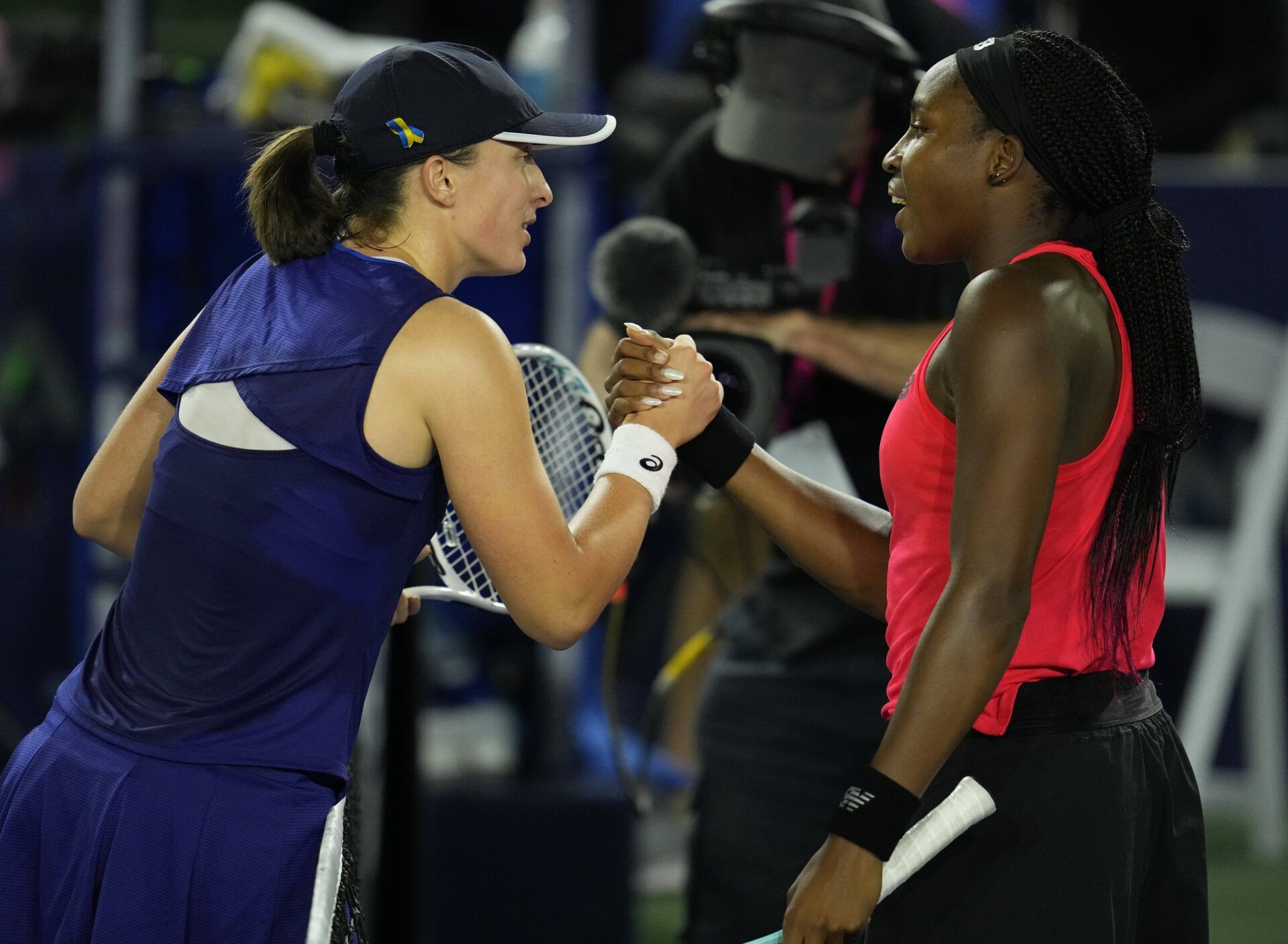 Iga Swiatek of Poland (left) greets Coco Gauff of the United States (right) after her win during the San Diego Open at Barnes Tennis Center.